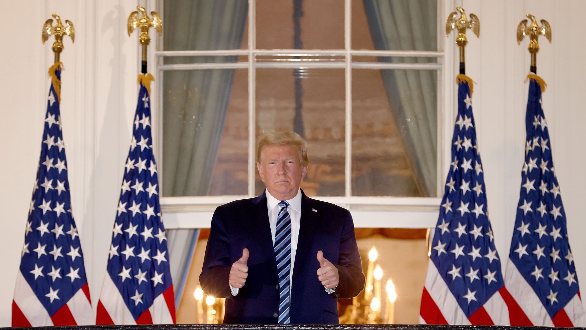 President Trump gives a twin thumbs-up after returning to the White House following his treatment for the coronavirus.