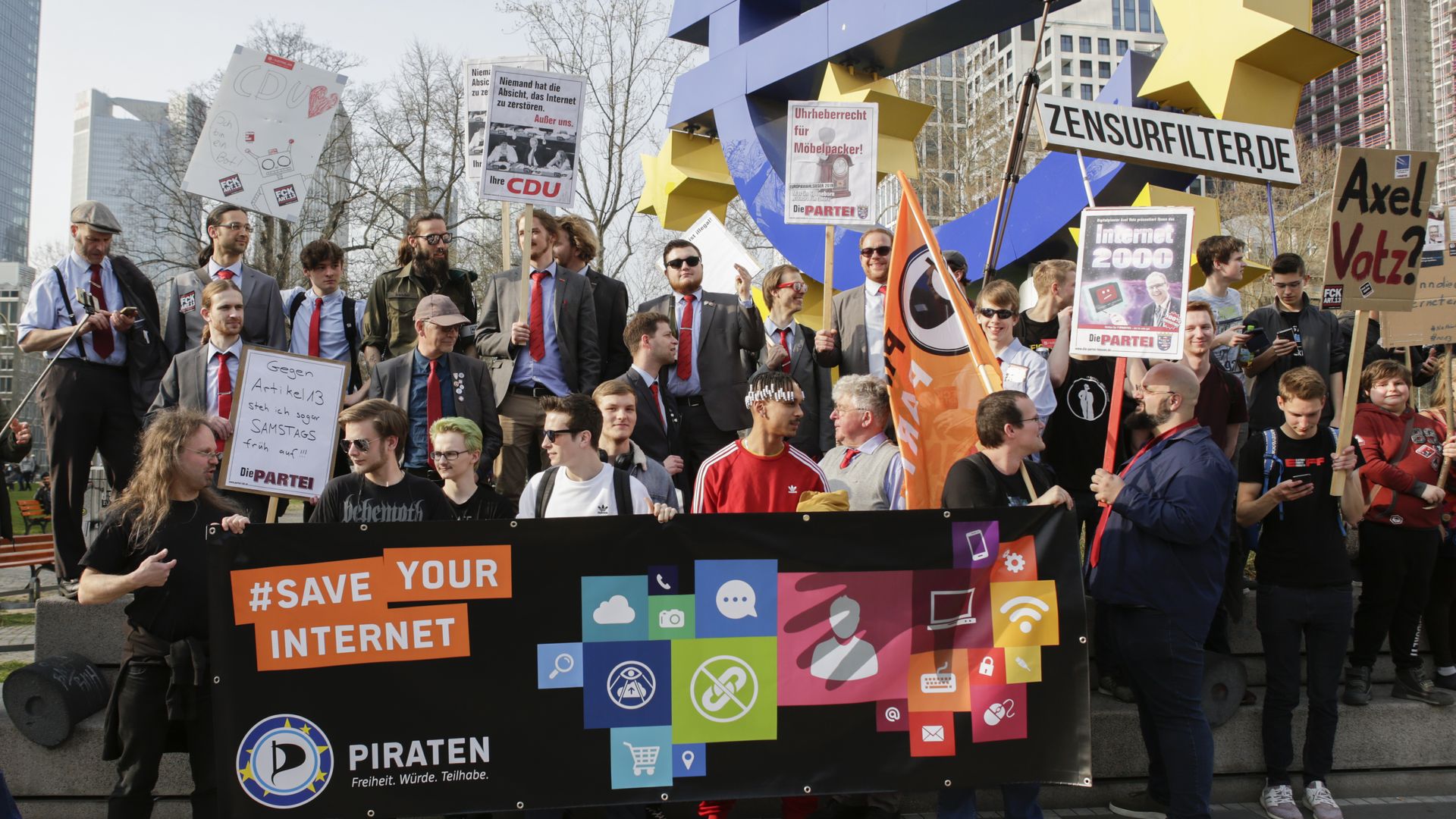 Protesters in Europe carry signs opposing EU copyright rules