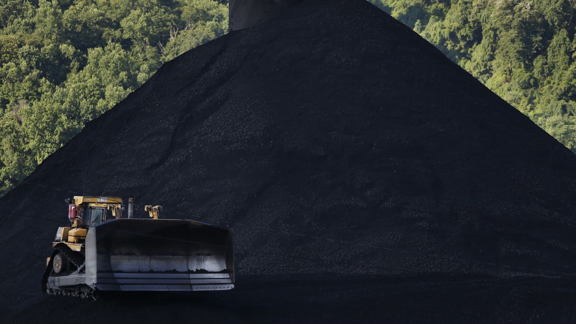 A operating on a mound of coal in London, West Virginia, in July 2018.