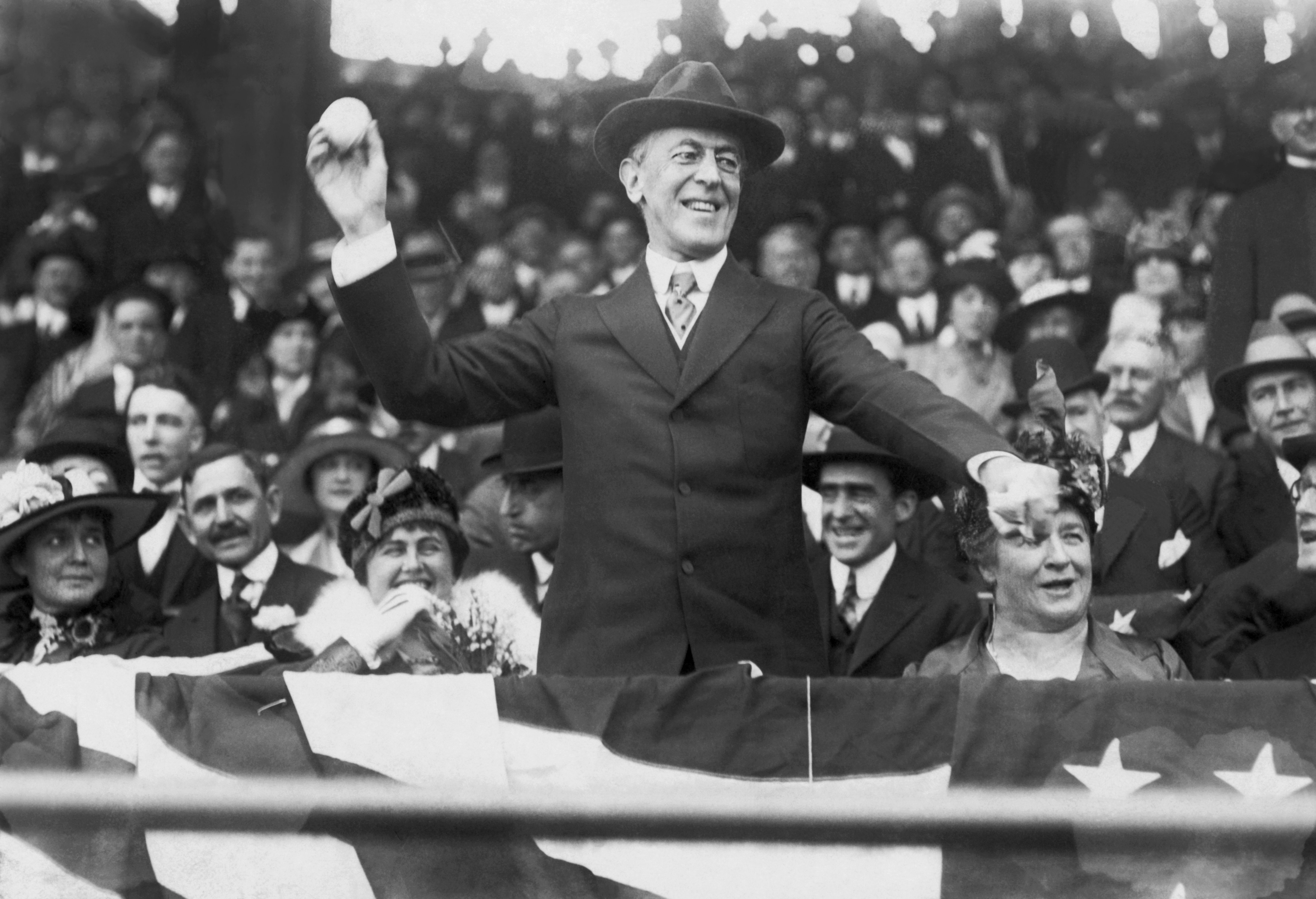 Black and white picture of President Woodrow Wilson about to throw a baseball