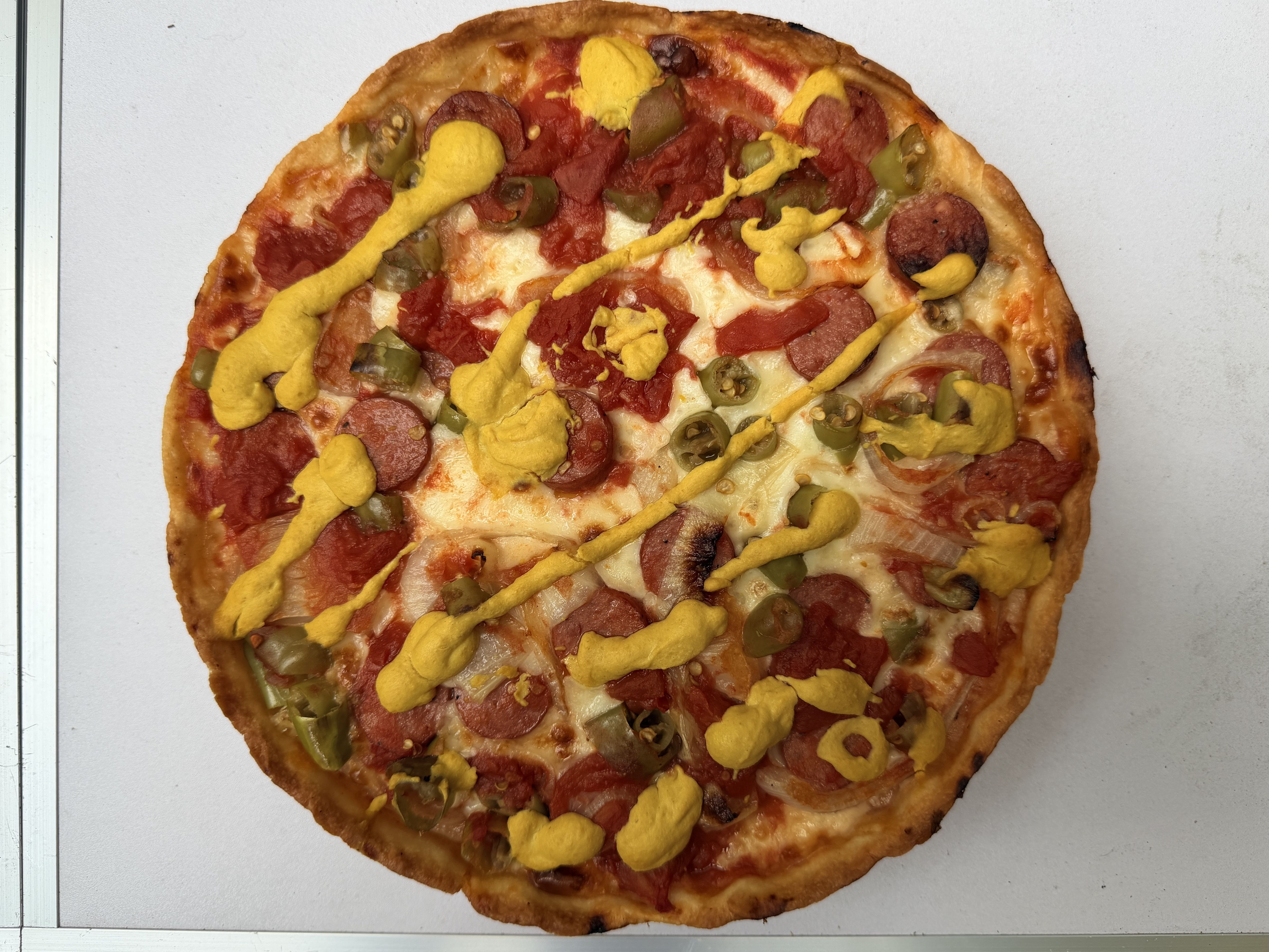 pizza with mustard on it