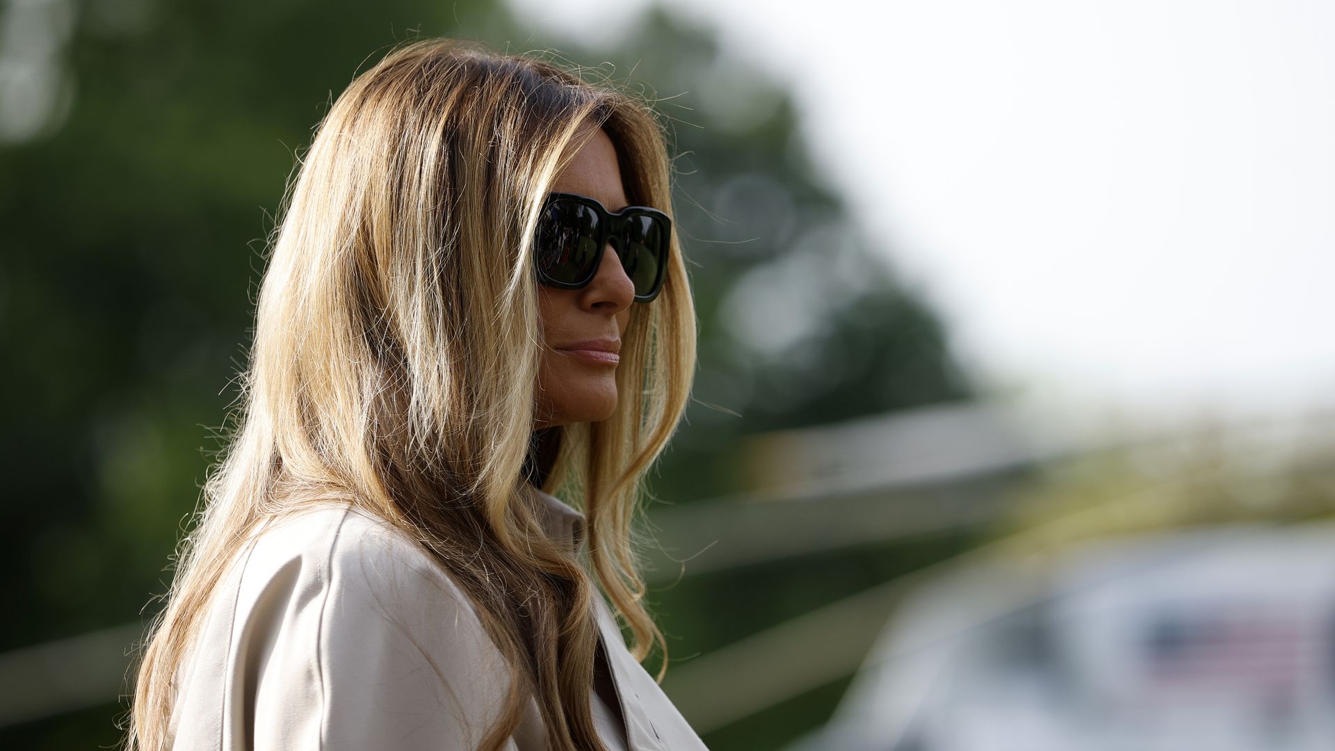 Melania Trump is shown in profile, wearing sunglasses.