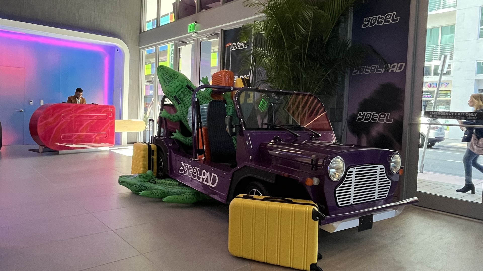 The lobby of YotelPad, which features an electric buggy and a front desk in the shape of a popsicle.