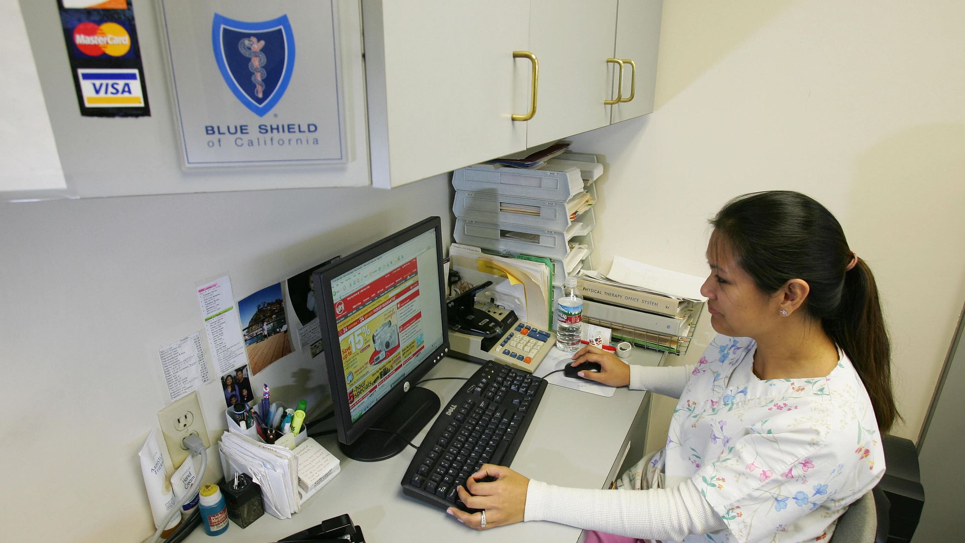 A medical billing specialist sits at her computer