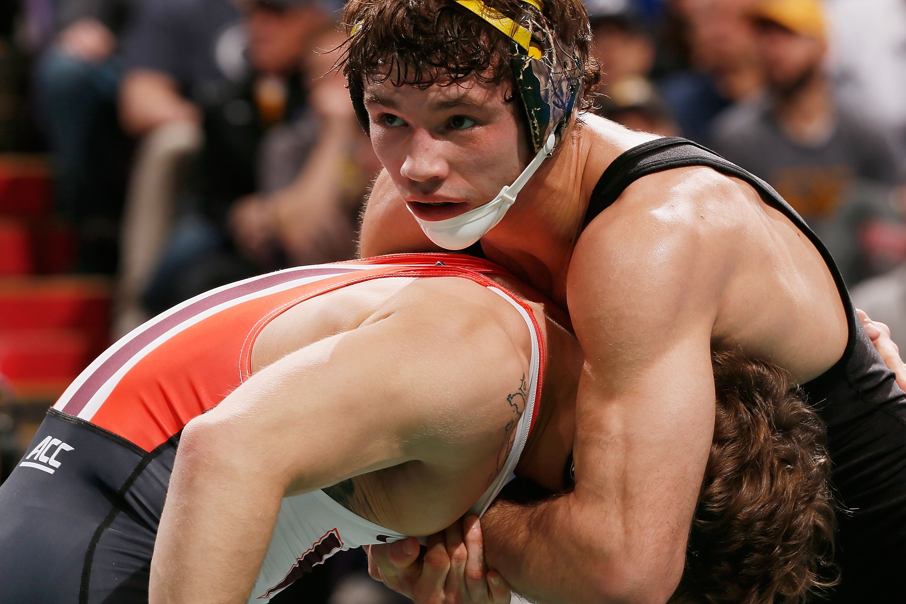 Thomas Gilman of Iowa grabs his opponent during a 125lb consolation match in St. Louis, Missouri. 
