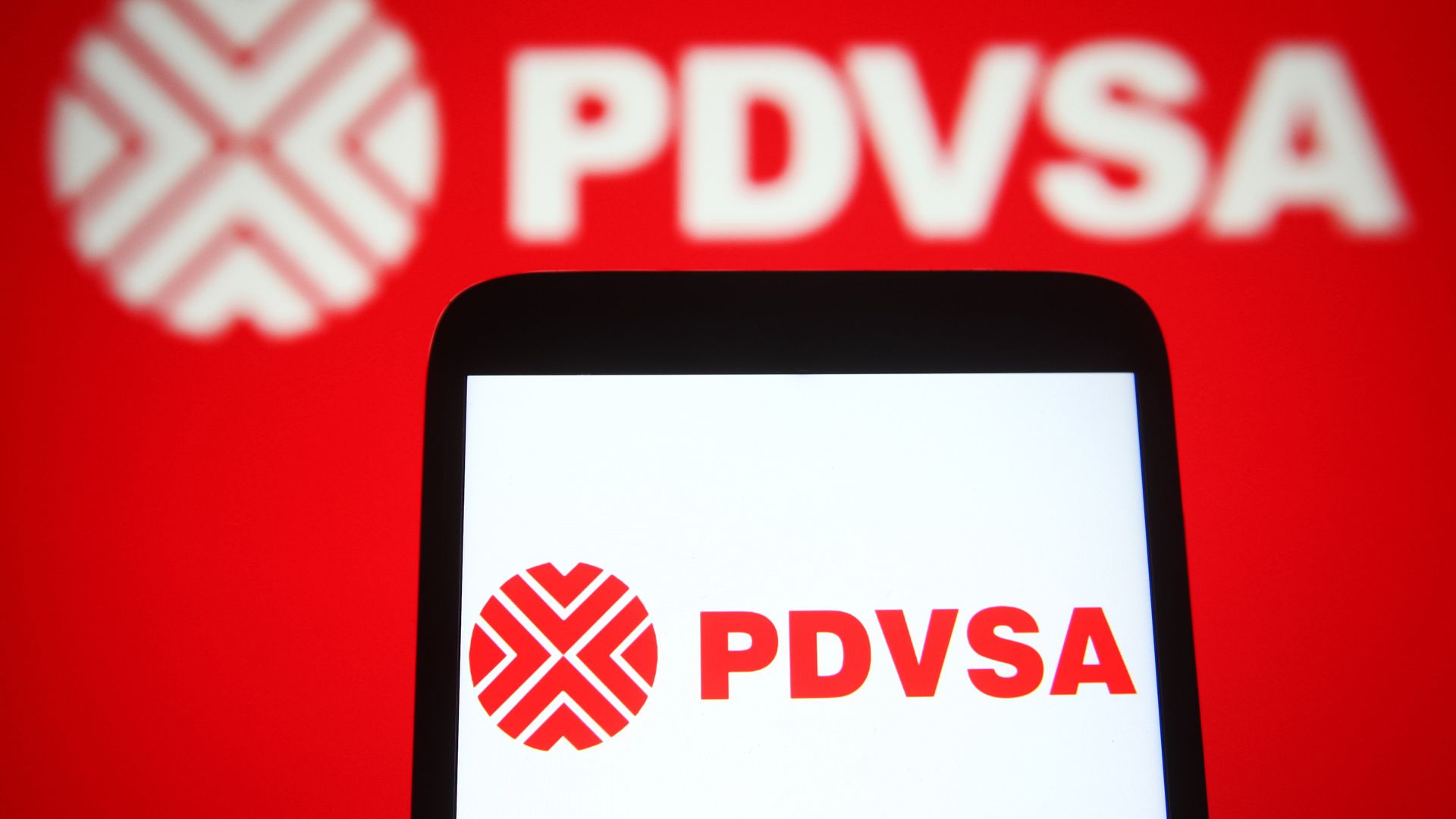 The logo of PDVSA, Venezuela's state-owned oil company, on a smart phone and on a computer screen.