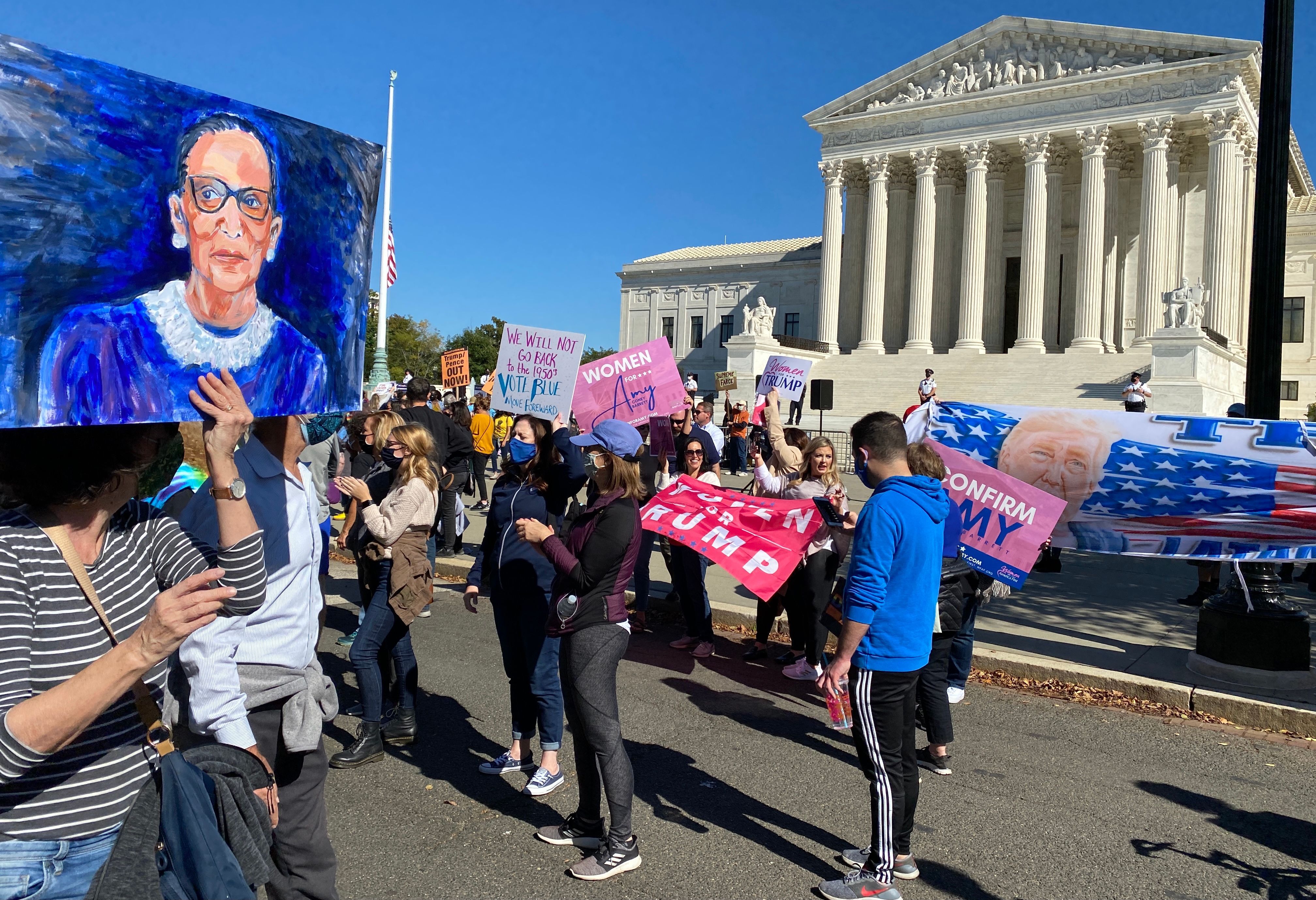 Women's march participants look on to supporters of Trump and his Supreme Court nominee. 
