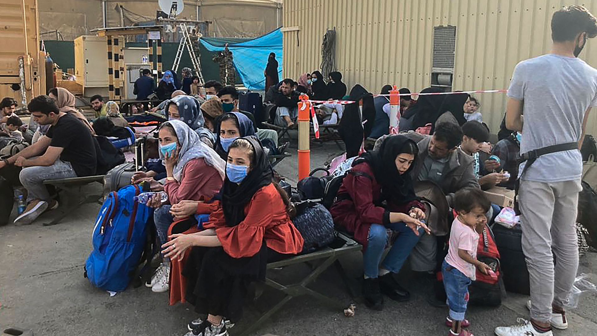 People wait to be evacuated from Afghanistan at the airport in Kabul 