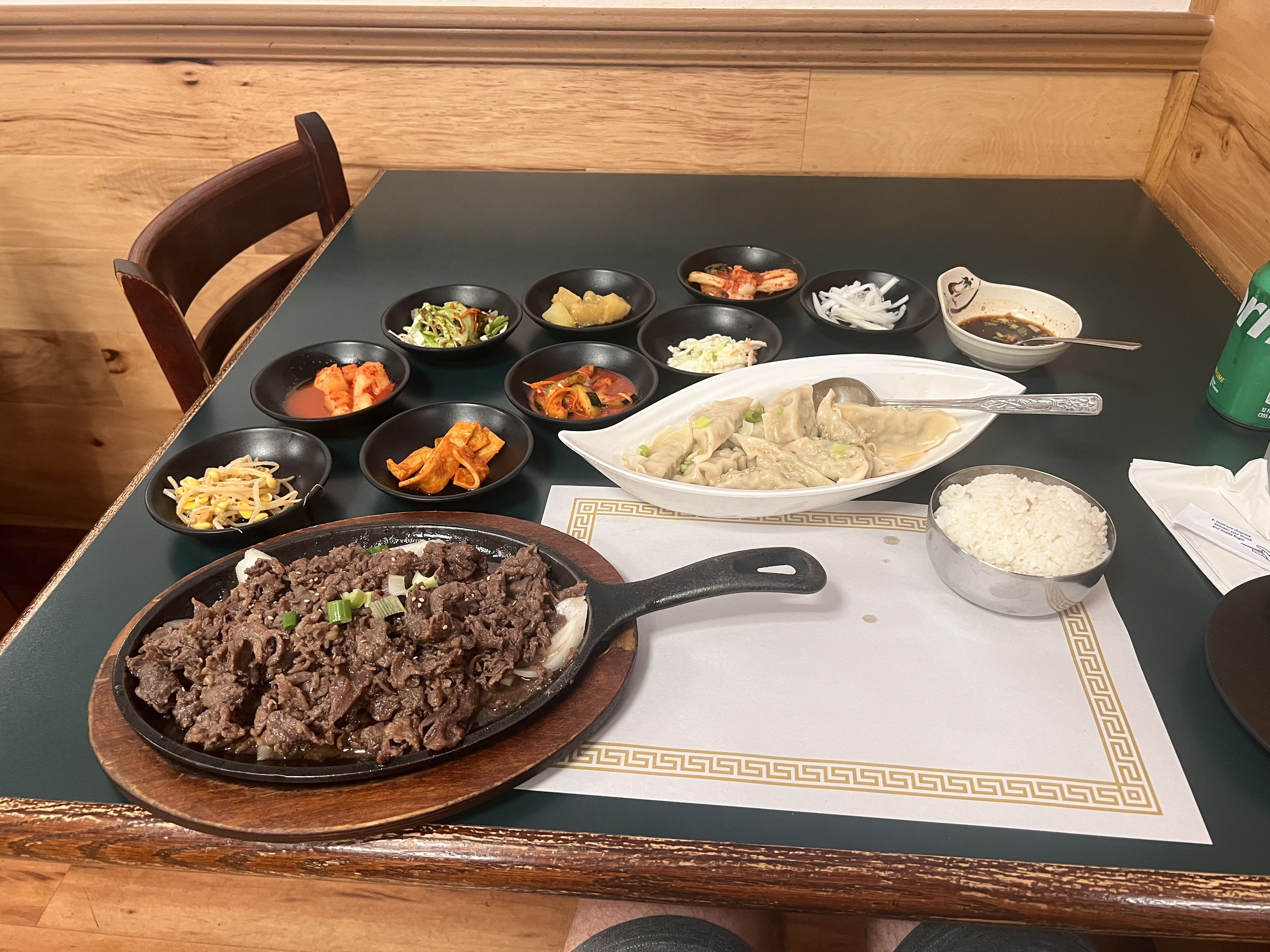 A spread of food with beef bulgogi and potstickers at Min-Ga