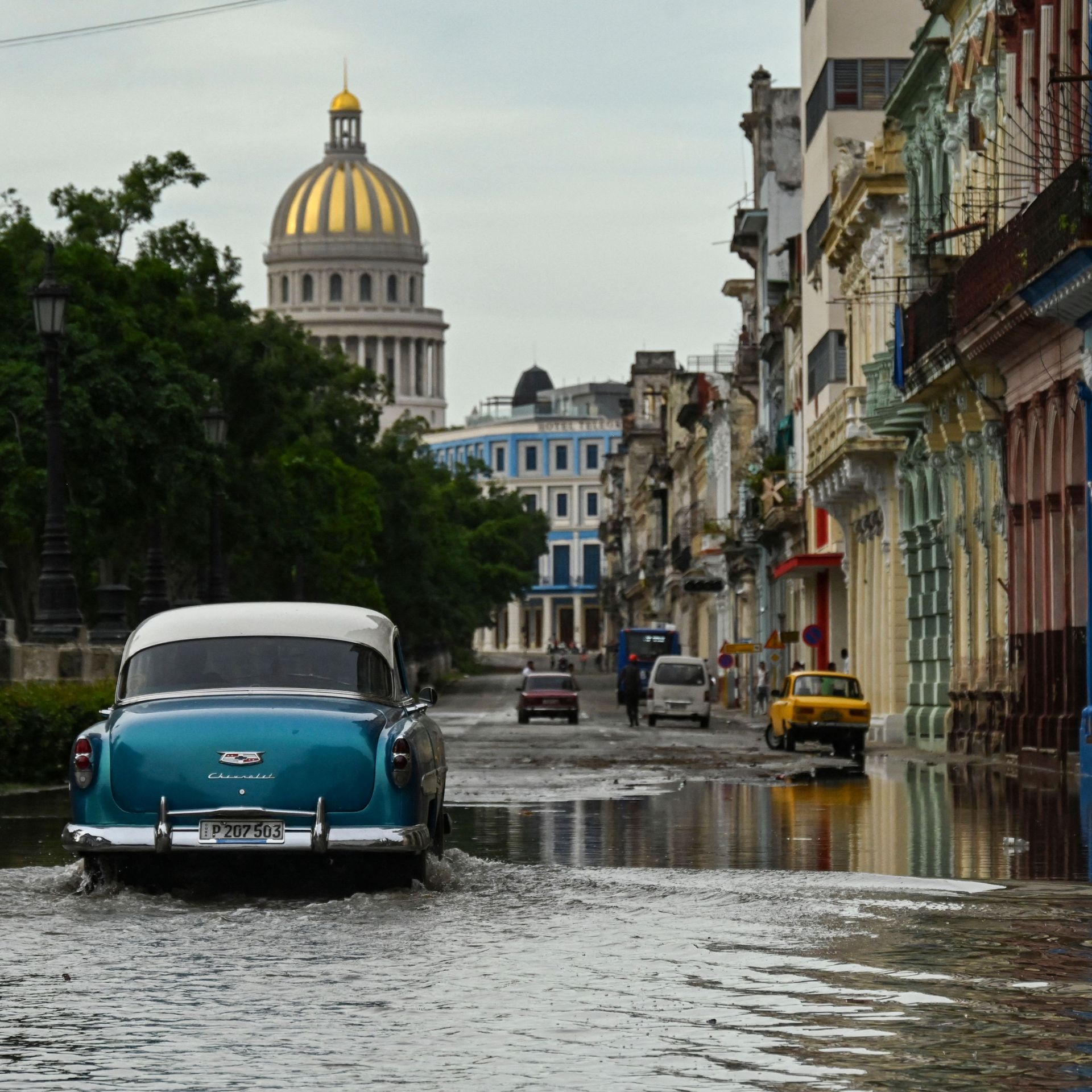 car drives through a flooded street in Havana, Cuba