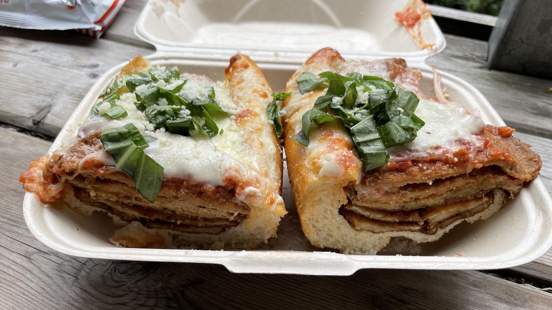 A photo of two eggplant parmesan sandwiches.