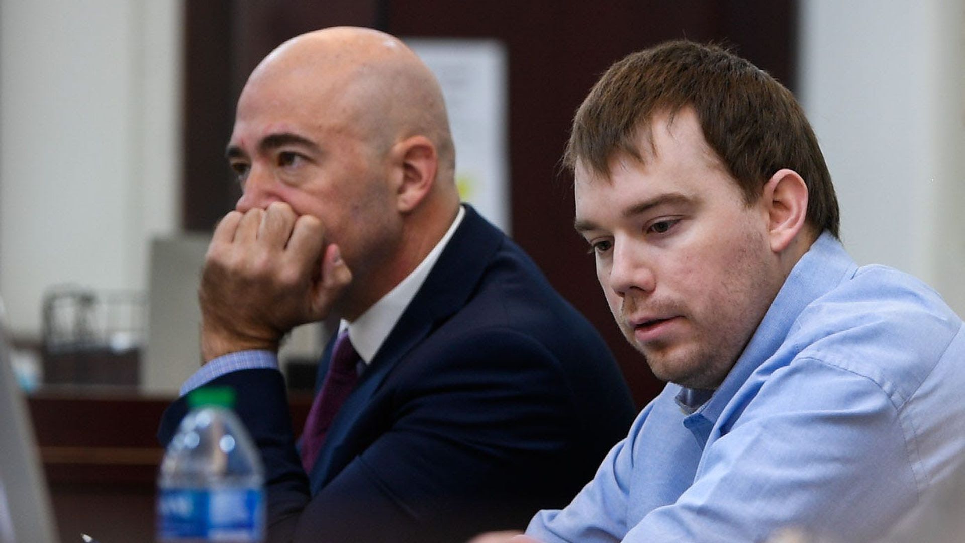 Travis Reinking, right, in court in a blue shirt