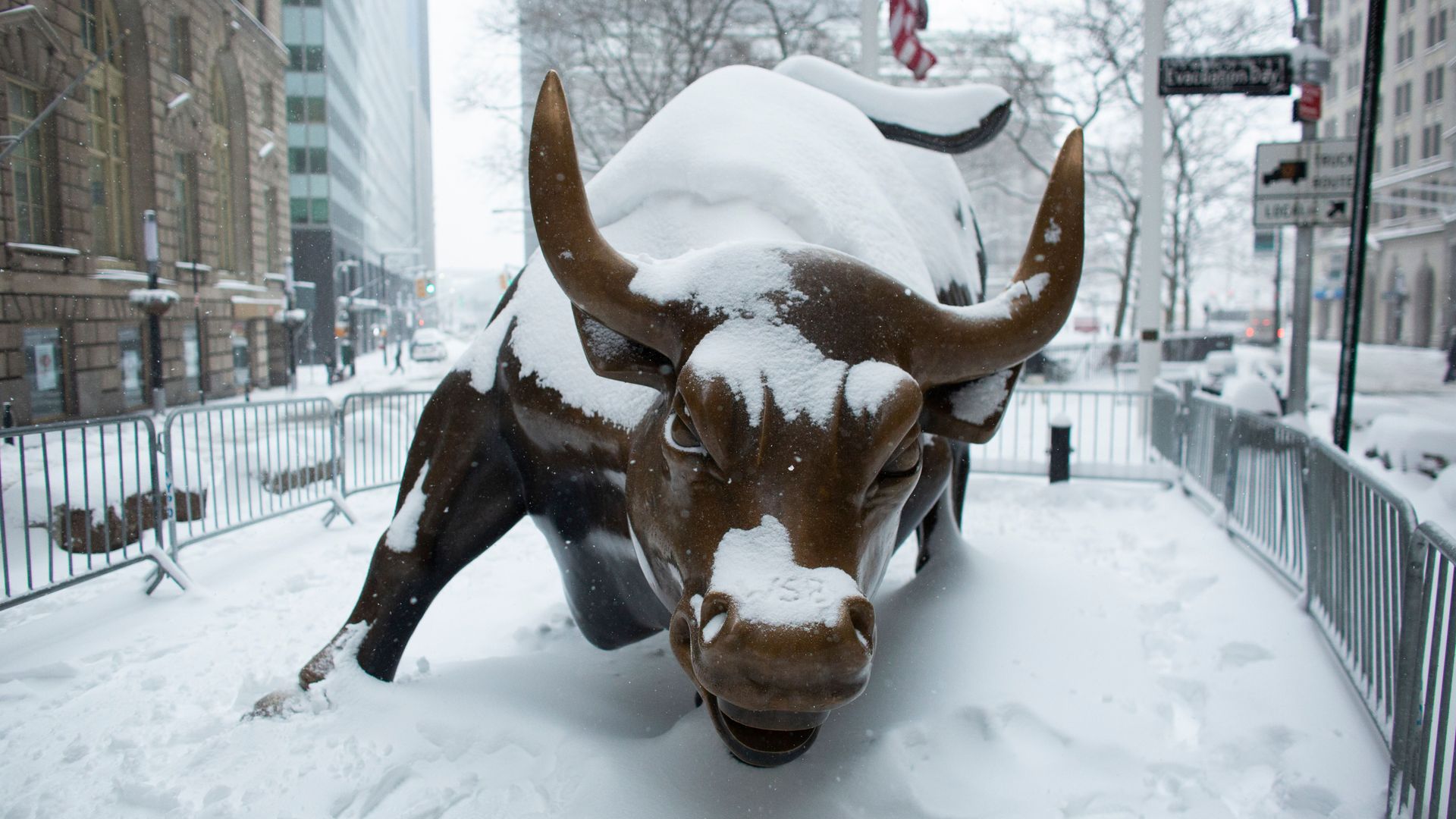 The Charging Bull Statue is covered by snow in Lower Manhattan during a winter storm on February 1, 2021