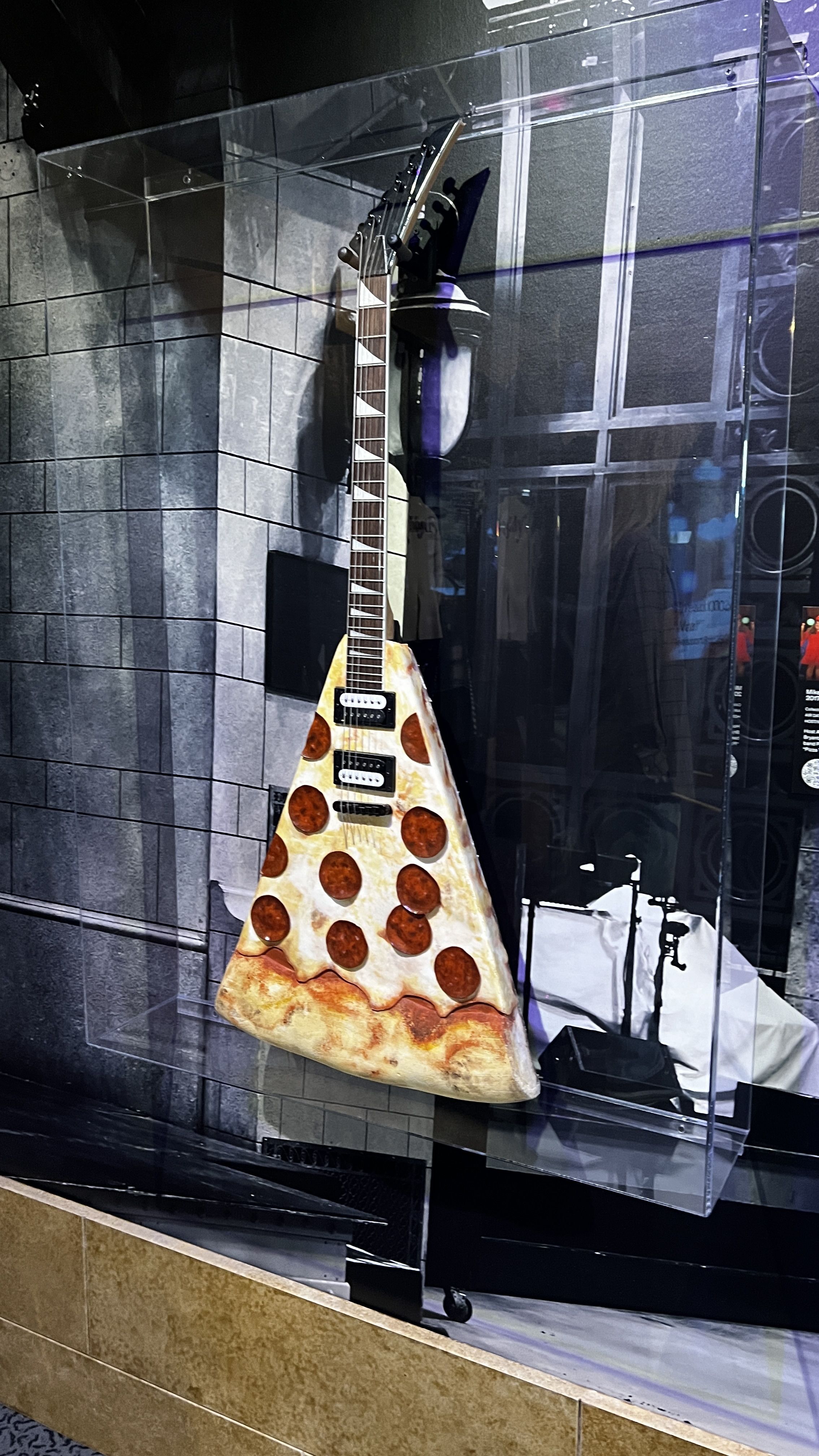 A guitar shaped like a pizza. 