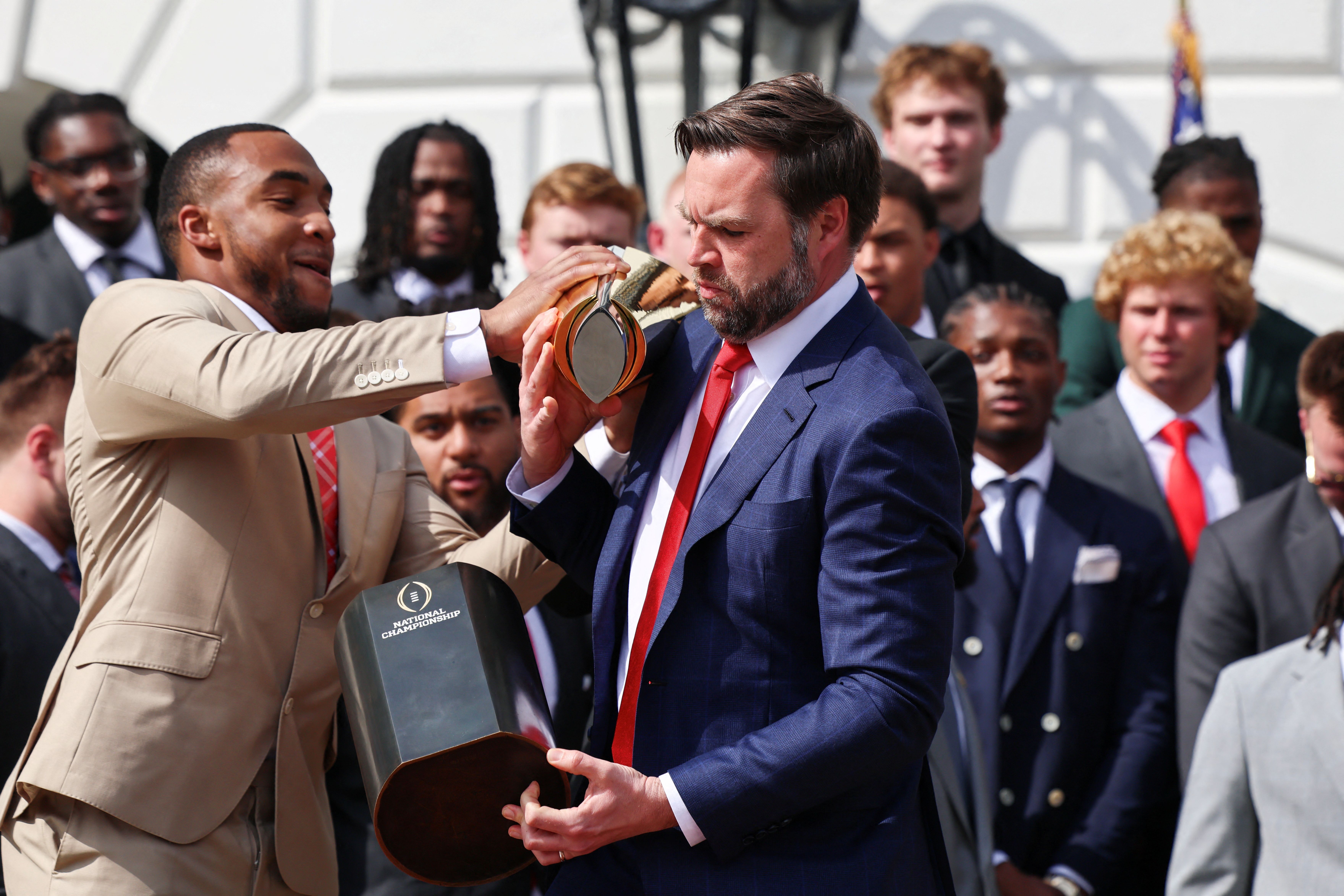 Vice President JD Vance bobbles the college football national championship trophy at a White House ceremony with Ohio State yesterday.