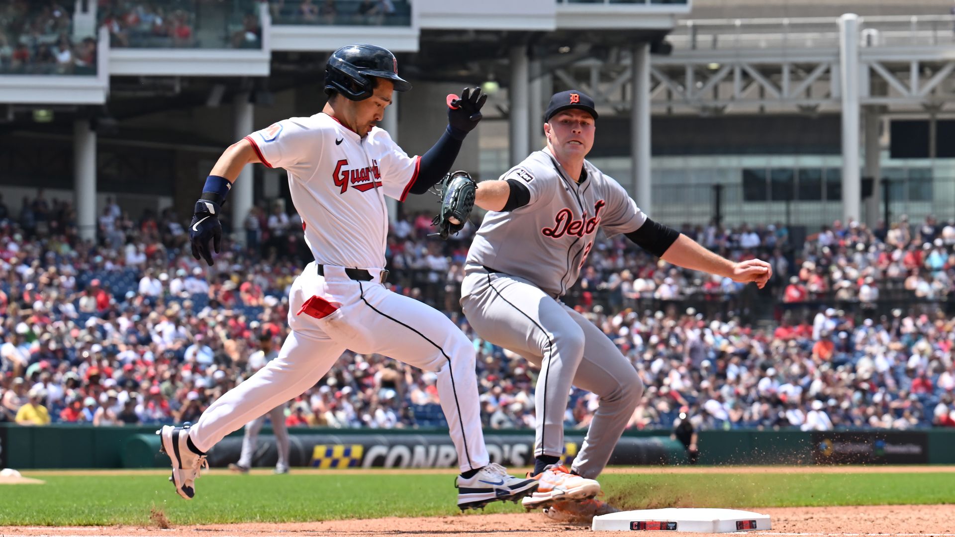 Steven Kwan #38 of the Cleveland Guardians stretches a single as starting pitcher Tarik Skubal #29 of the Detroit Tigers tries.
