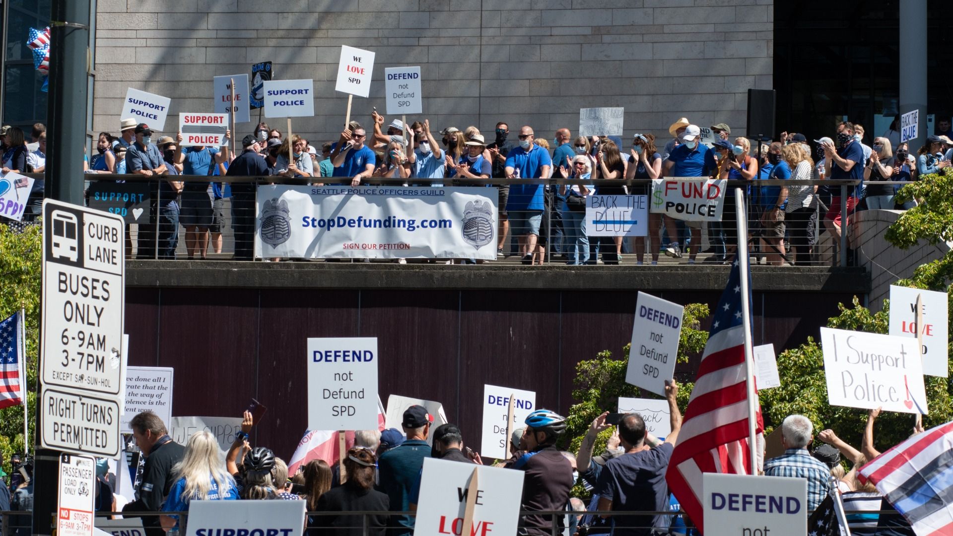 A crowd of people who oppose defunding police in Seattle gather to hear the police union president speak. 
