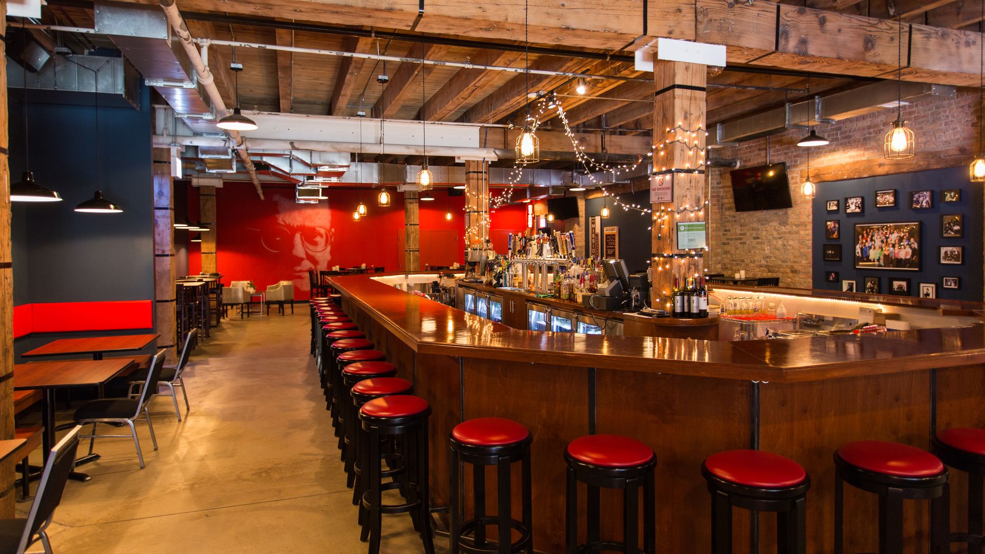 Photo of a bar with strings of lights hanging from ceiling. 