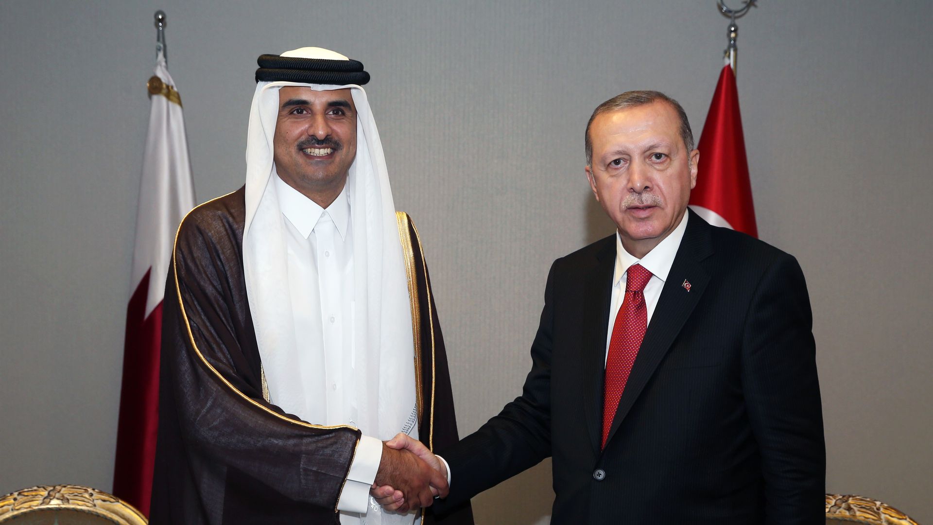 Qatar's emir and Turkey's president shaking hands