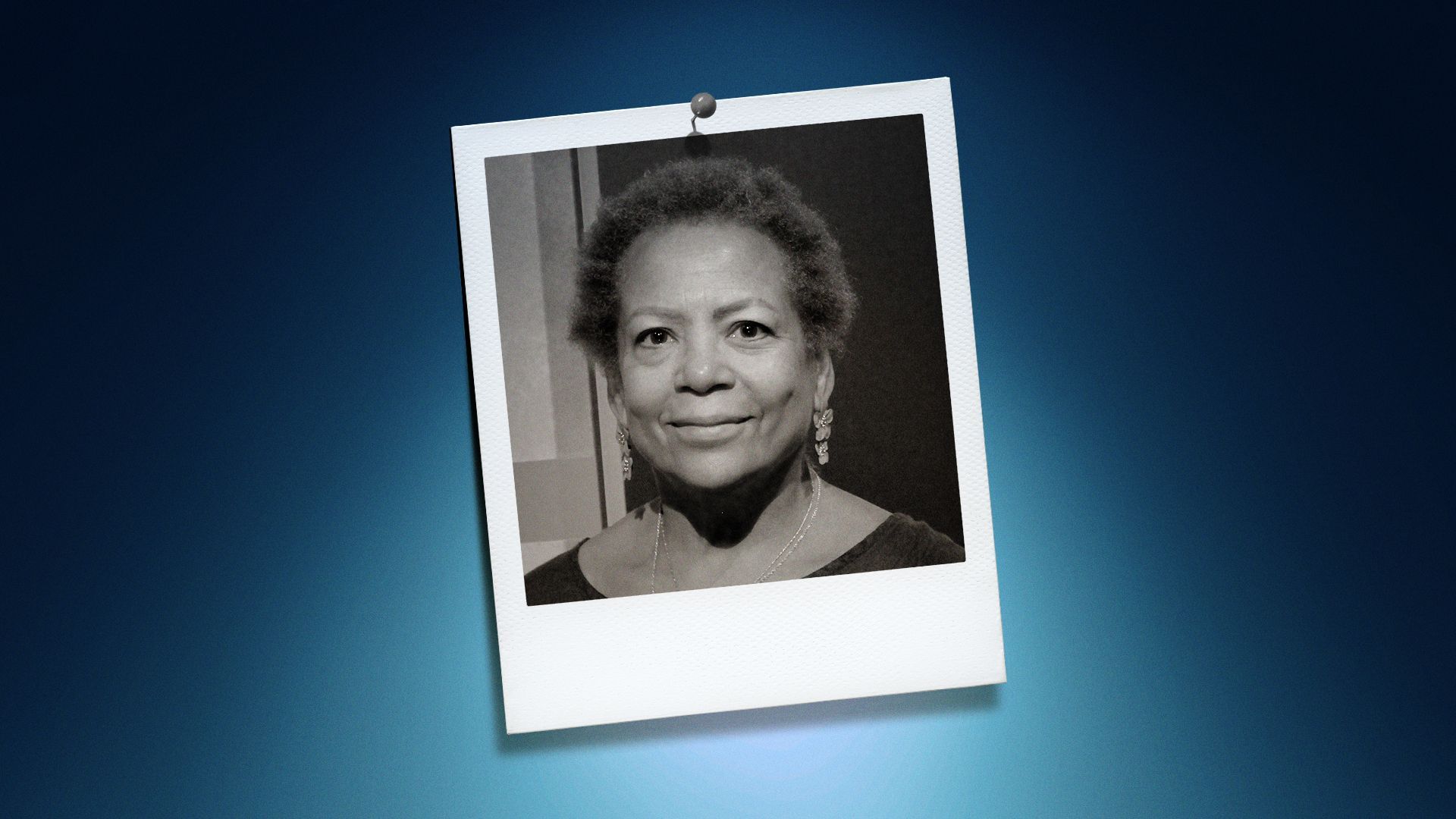 Photo illustration of Claire Oberon Garcia in the center of a Polaroid photo under a blue spotlight.