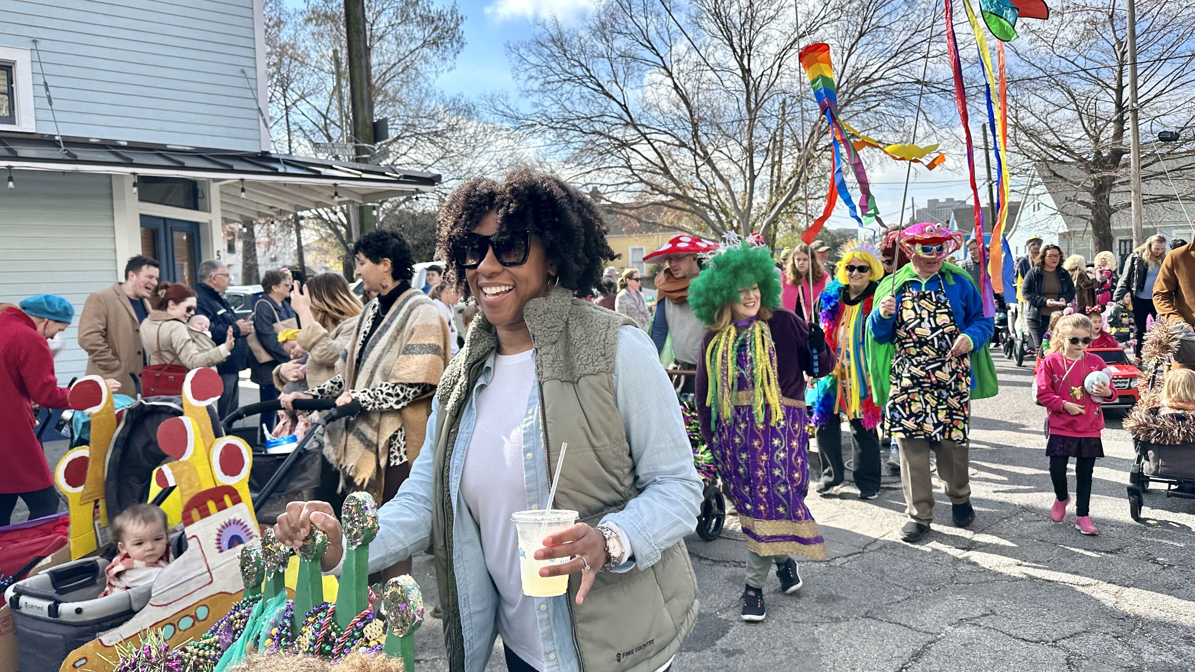 Photo shows children in costume walking in the Krewe of Confetti Kids parade in Algiers Point in New Orleans.