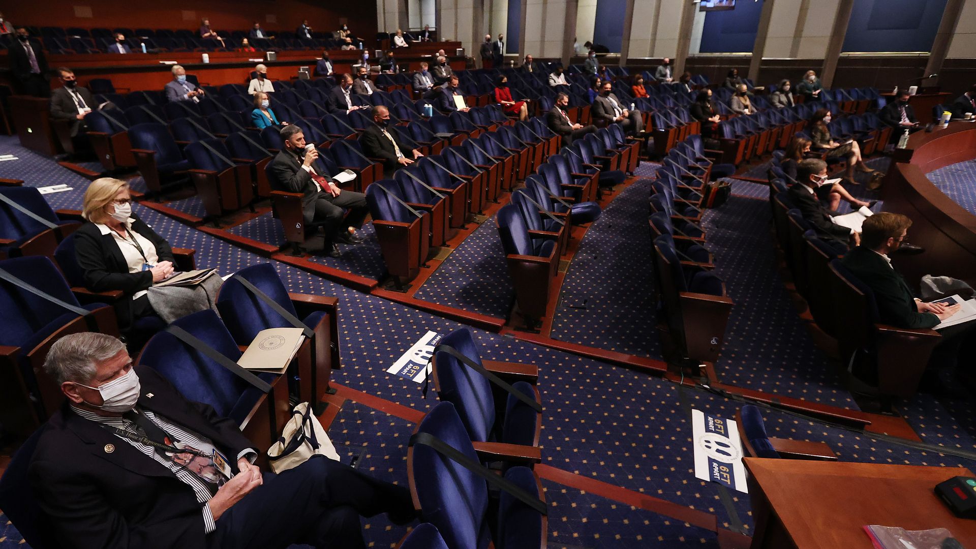 Members of congress sitting on the floor.