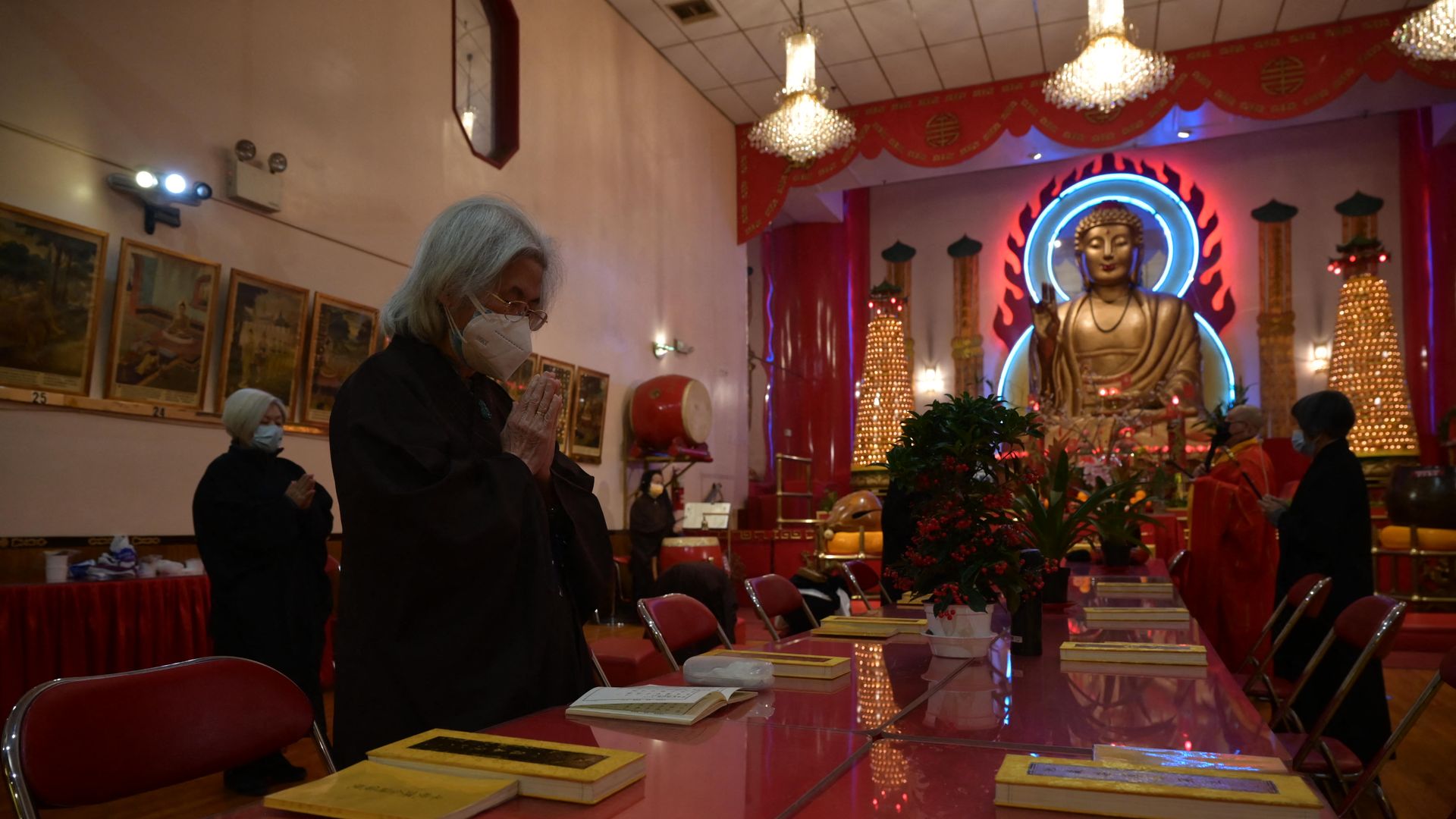 Worshippers offer prayers for victims of the Atlanta spa shooting in addition to the ongoing Covid-19 pandemic at the Mahayana Buddhist temple in Chinatown, New York City.