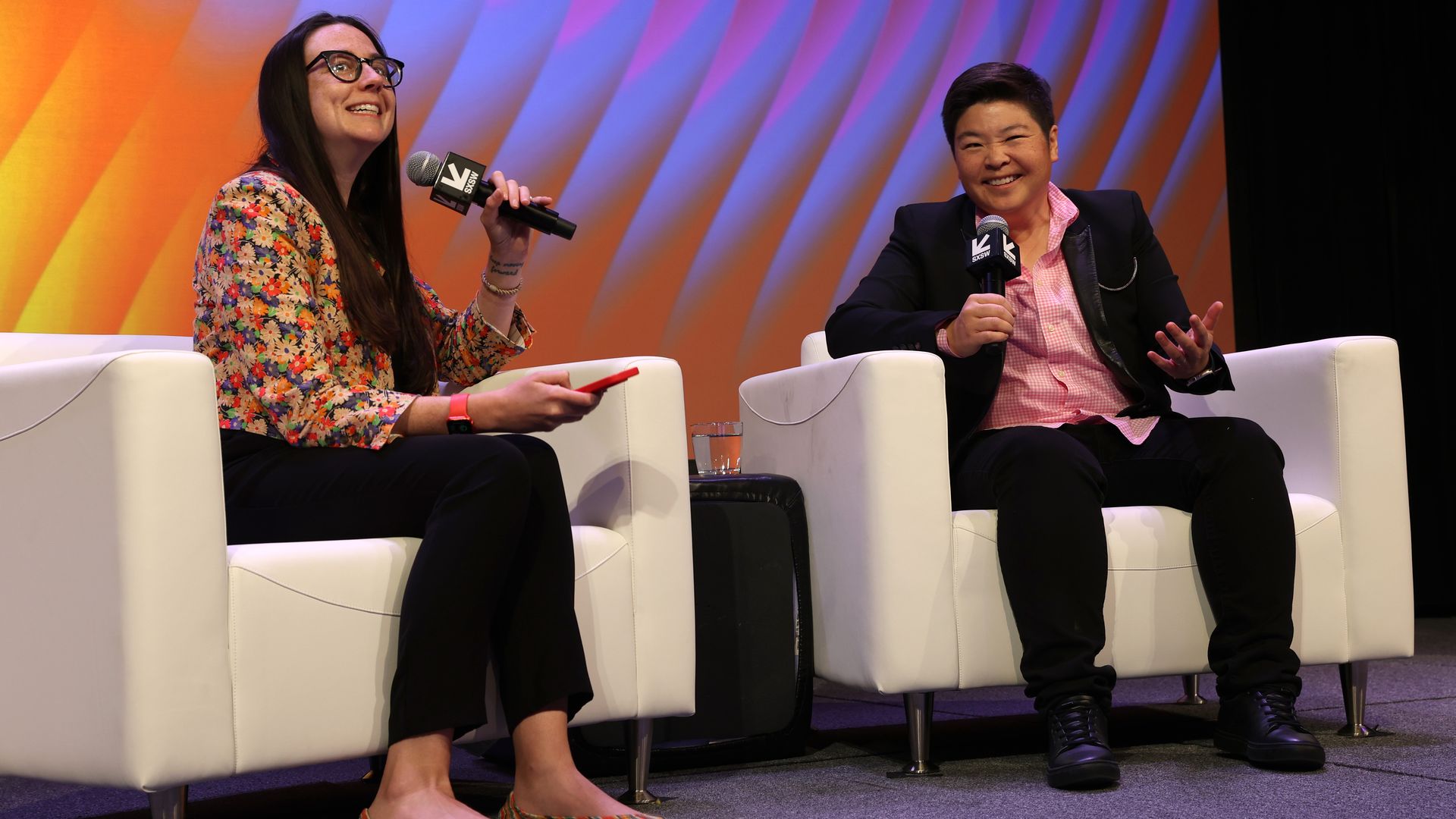 Axios' Kerry Flynn and Reddit's Jen Wong sitting in white chair side by side
