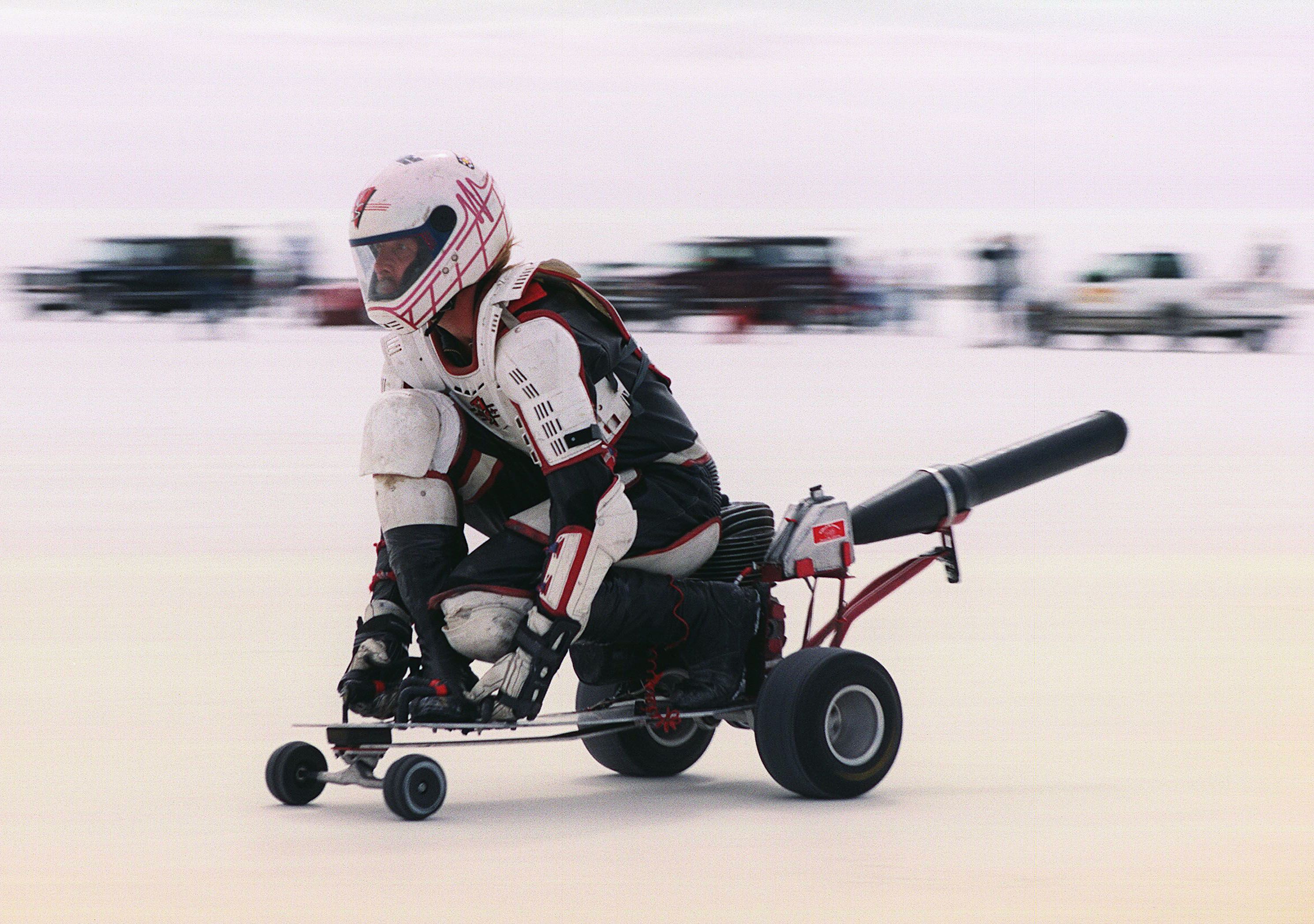 A skateboarder on a motorized skateboard racing at the Bonneville Salt Flats