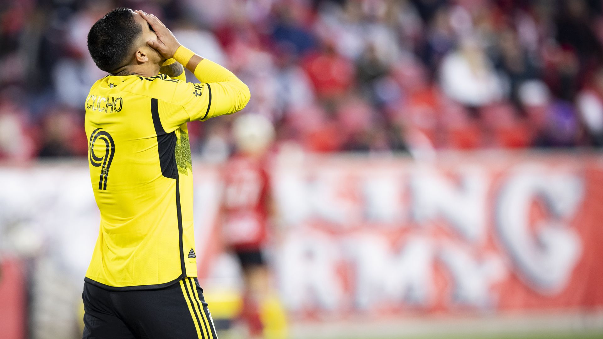 Cucho Hernandez reacts to a missed goal by putting his face in his hands
