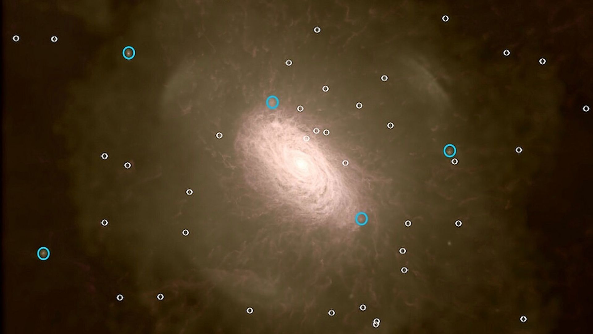 Image of the Milky Way Galaxy with bright galaxies circled in blue, and faint ones in white.