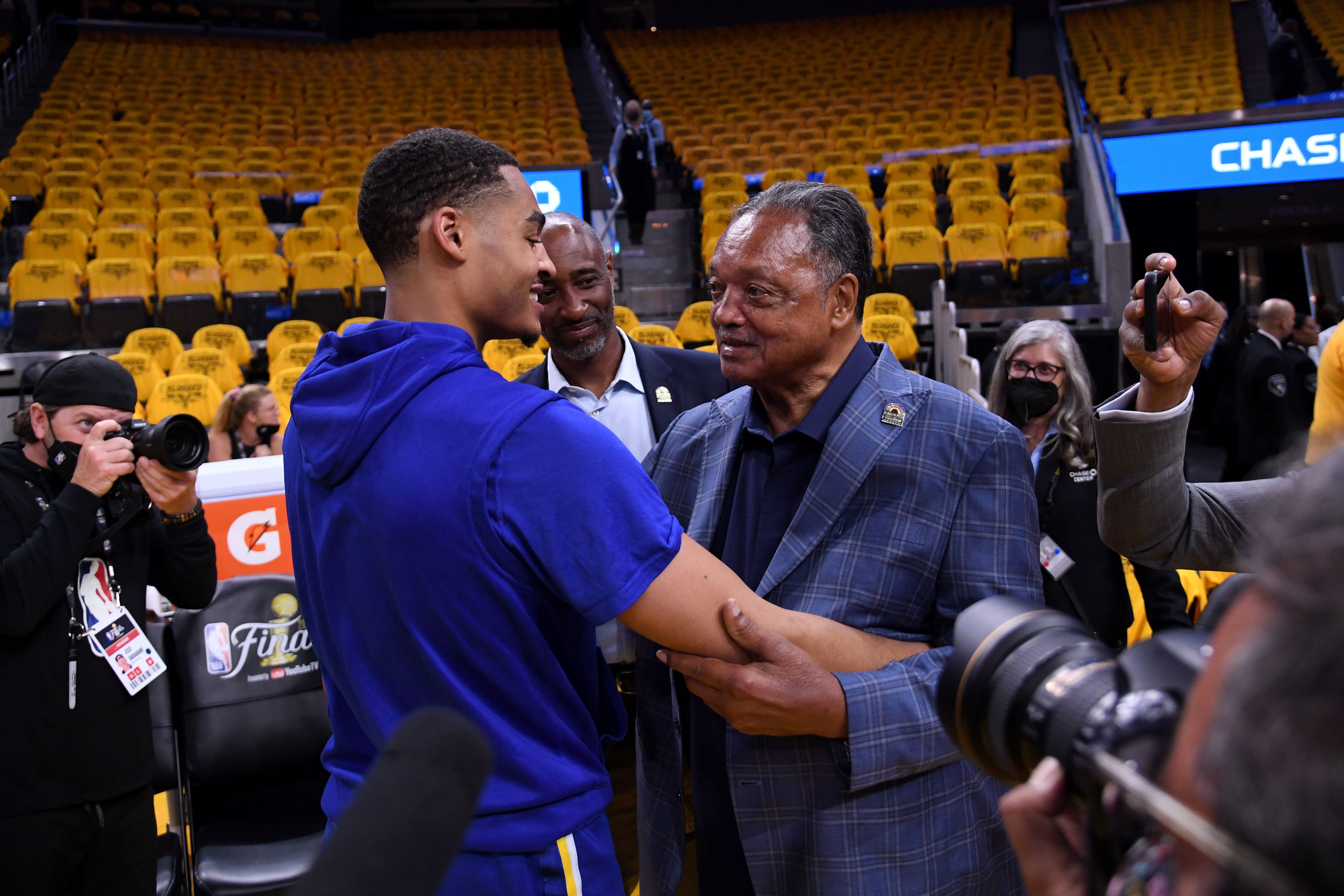 SAN FRANCISCO, CA - JUNE 13: Jordan Poole #3 of the Golden State Warriors talks with civil rights activist Rev. Jesse L. Jackson, Sr. before Game Five of the 2022 NBA Finals against the Boston Celtics on June 13, 2022 at Chase Center in San Francisco, California. NOTE TO USER: User expressly acknowl