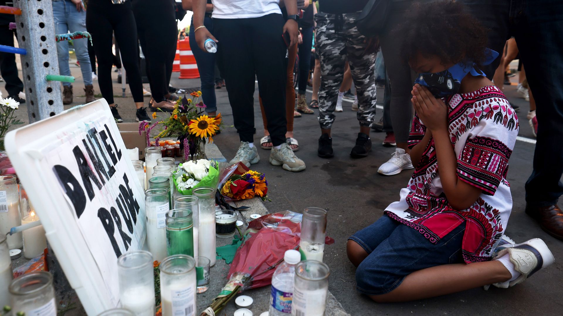 A child kneels in prayer at a make shift memorial at the site where Daniel Prude was arrested on September 03, 2020 in Rochester, New York. 
