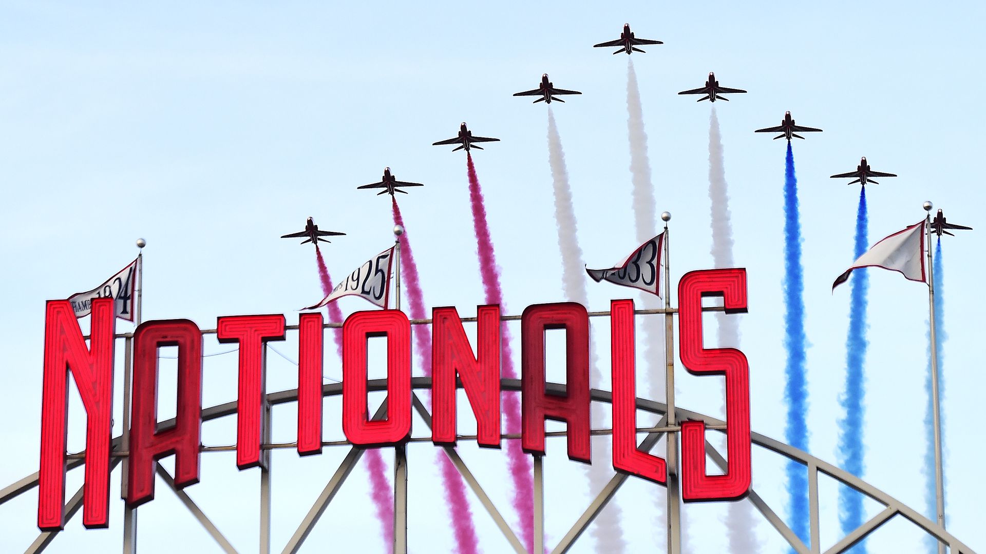 Planes lift off in formation above the Washington Nationals marquee at Nats Park in Washington, D.C. 