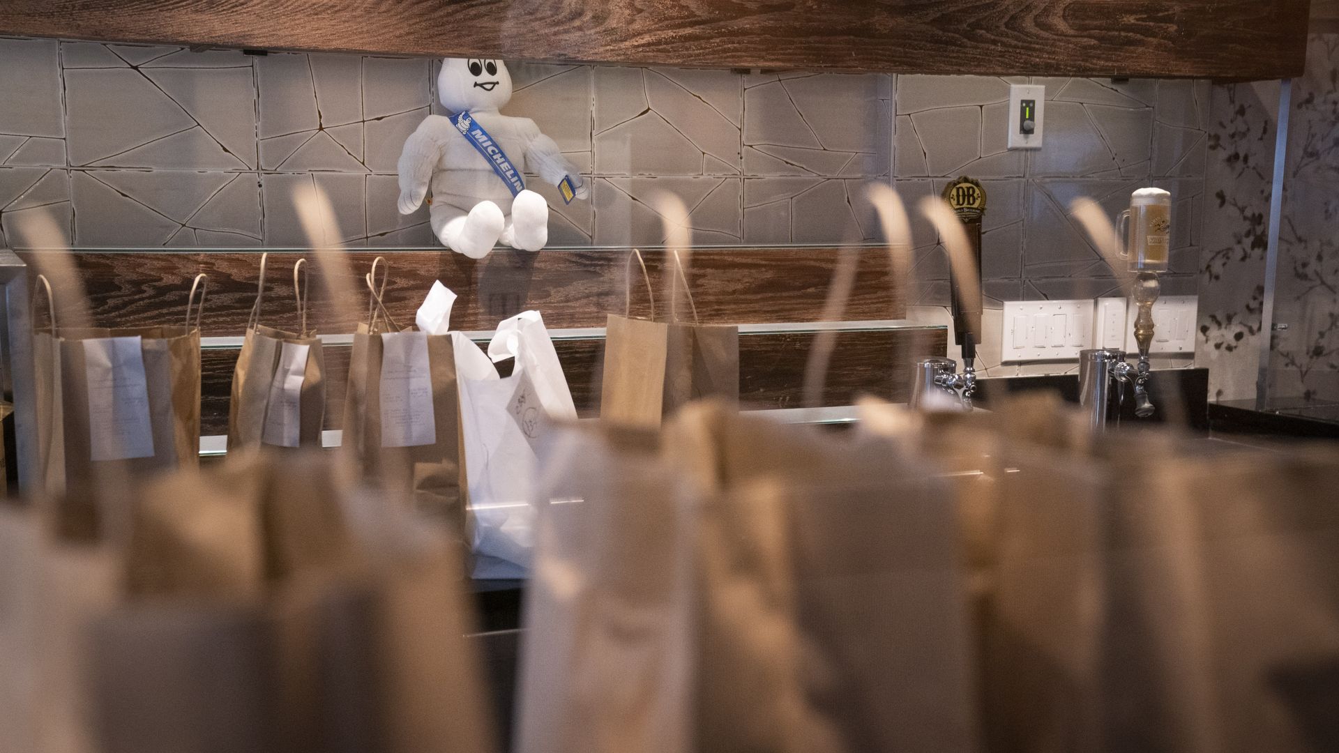 A restaurant with takeout bags lined up on the counters