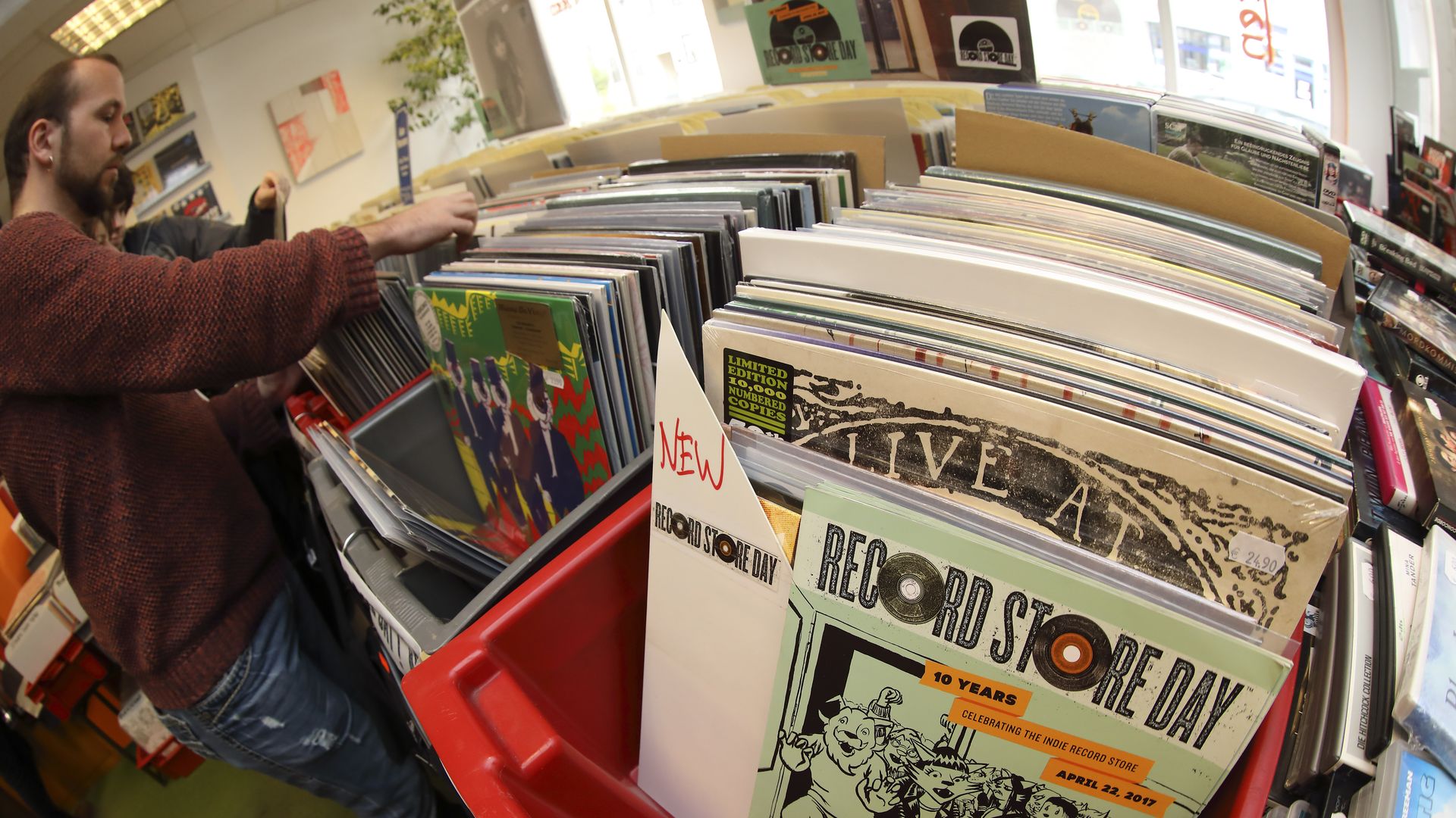 a shot from a fish eye lens of people sorting through records