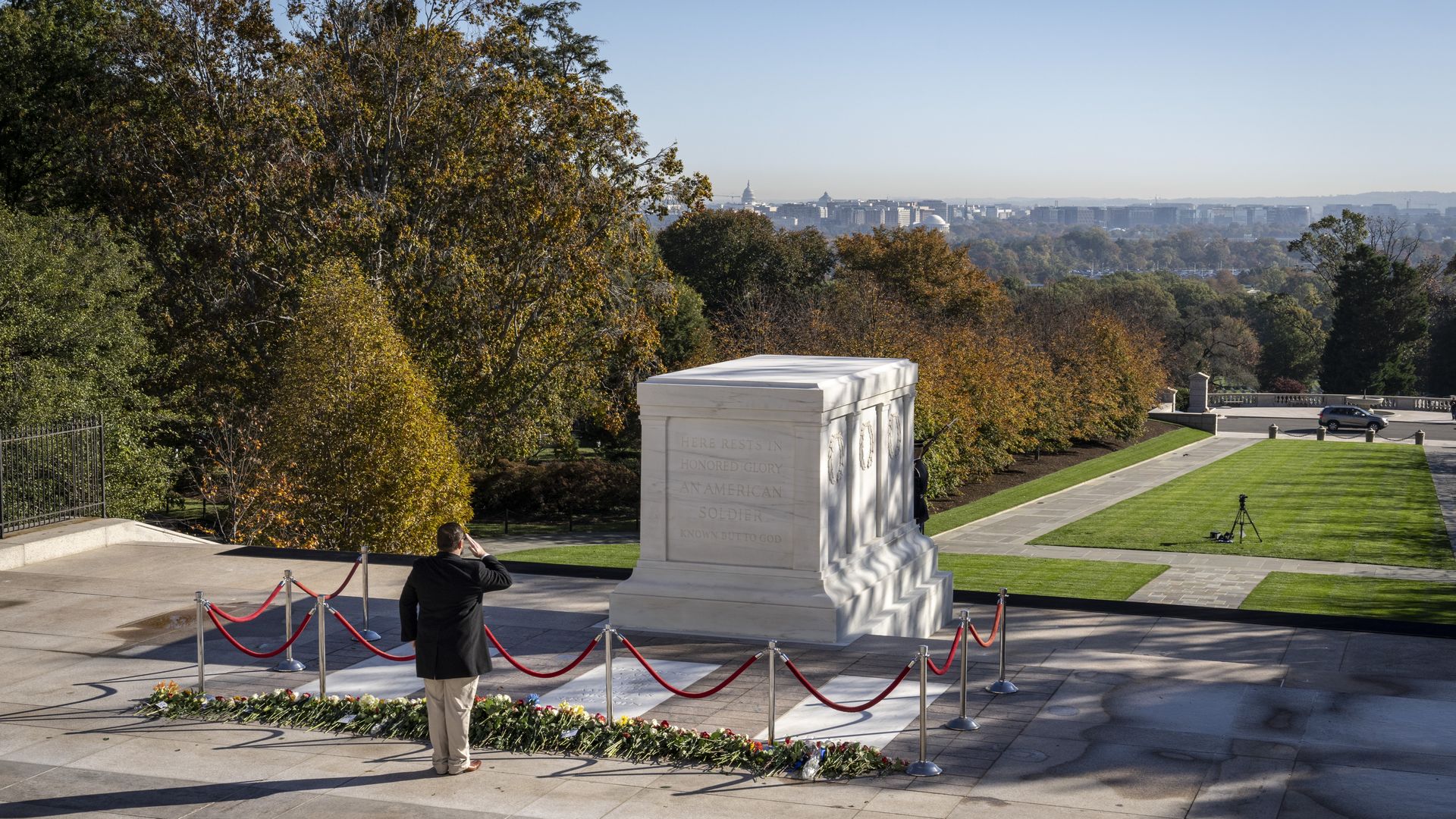 A man is seen saluting at the Tomb of the Unknown Soldier.
