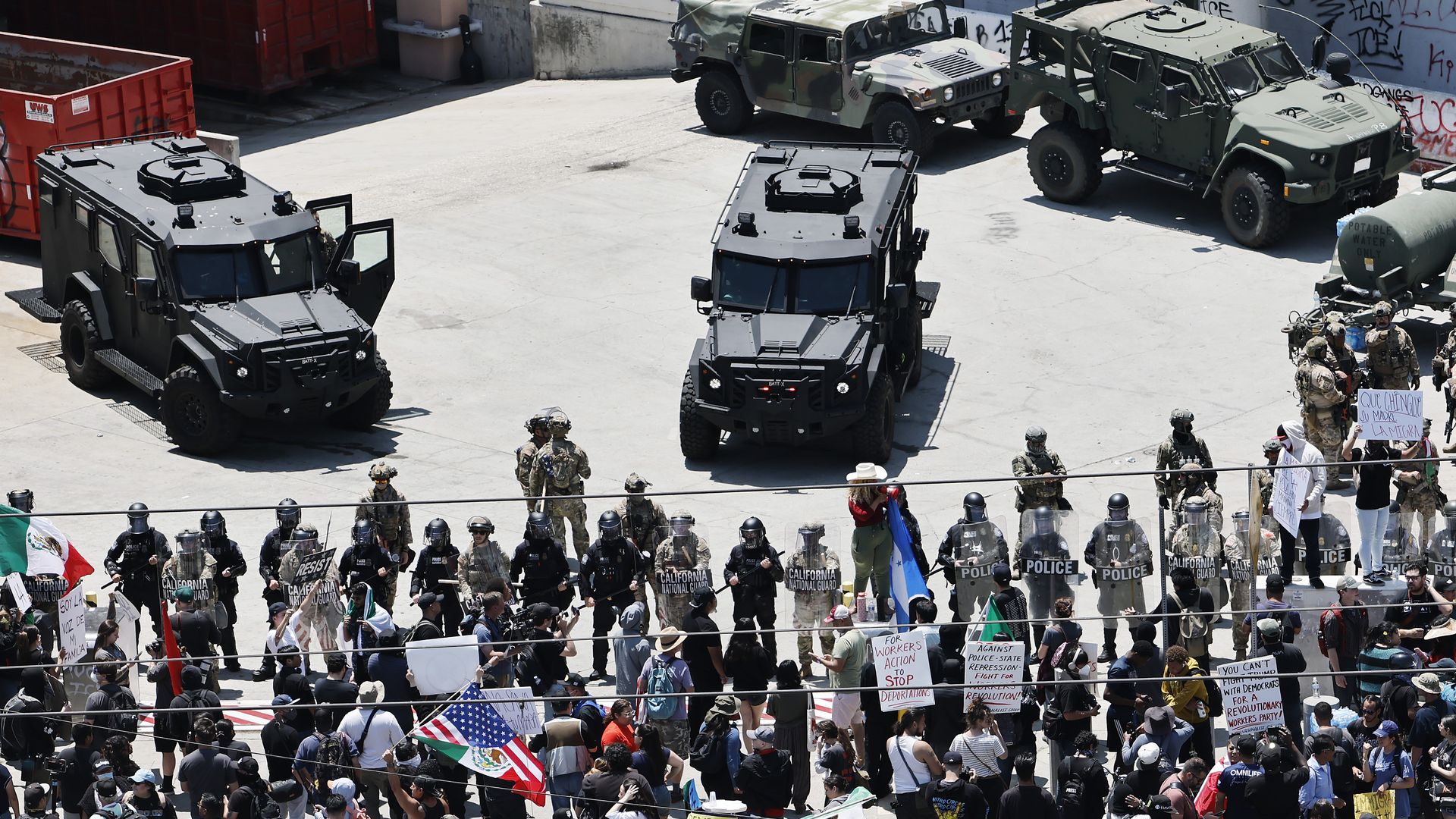Protesters gather in front of California National Guard soldiers and LAPD officers guarding the Edward R. Roybal Federal building as protests continue in Los Angeles following four days of clashes with police after a series of immigration raids on June 10, 2025 in Los Angeles, California.