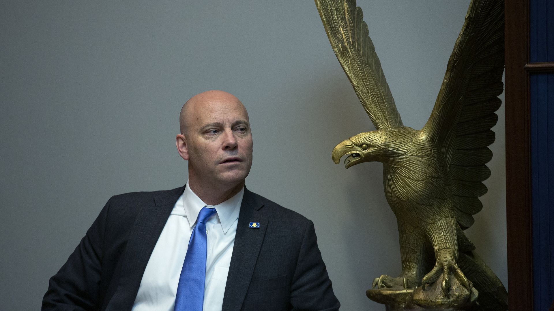 Marc Short sits next to an eagle statue at the White House in March 2020.