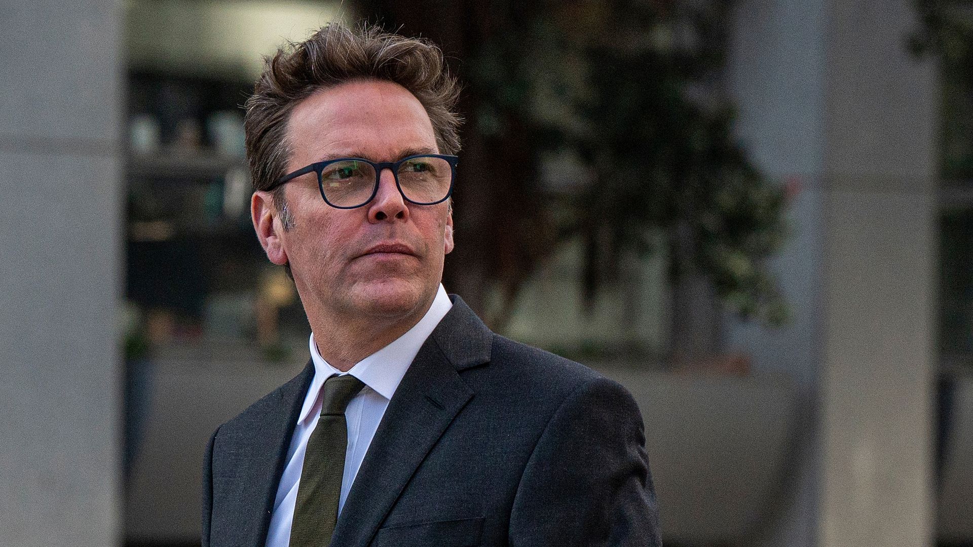 James Murdoch wears a suit and tie.