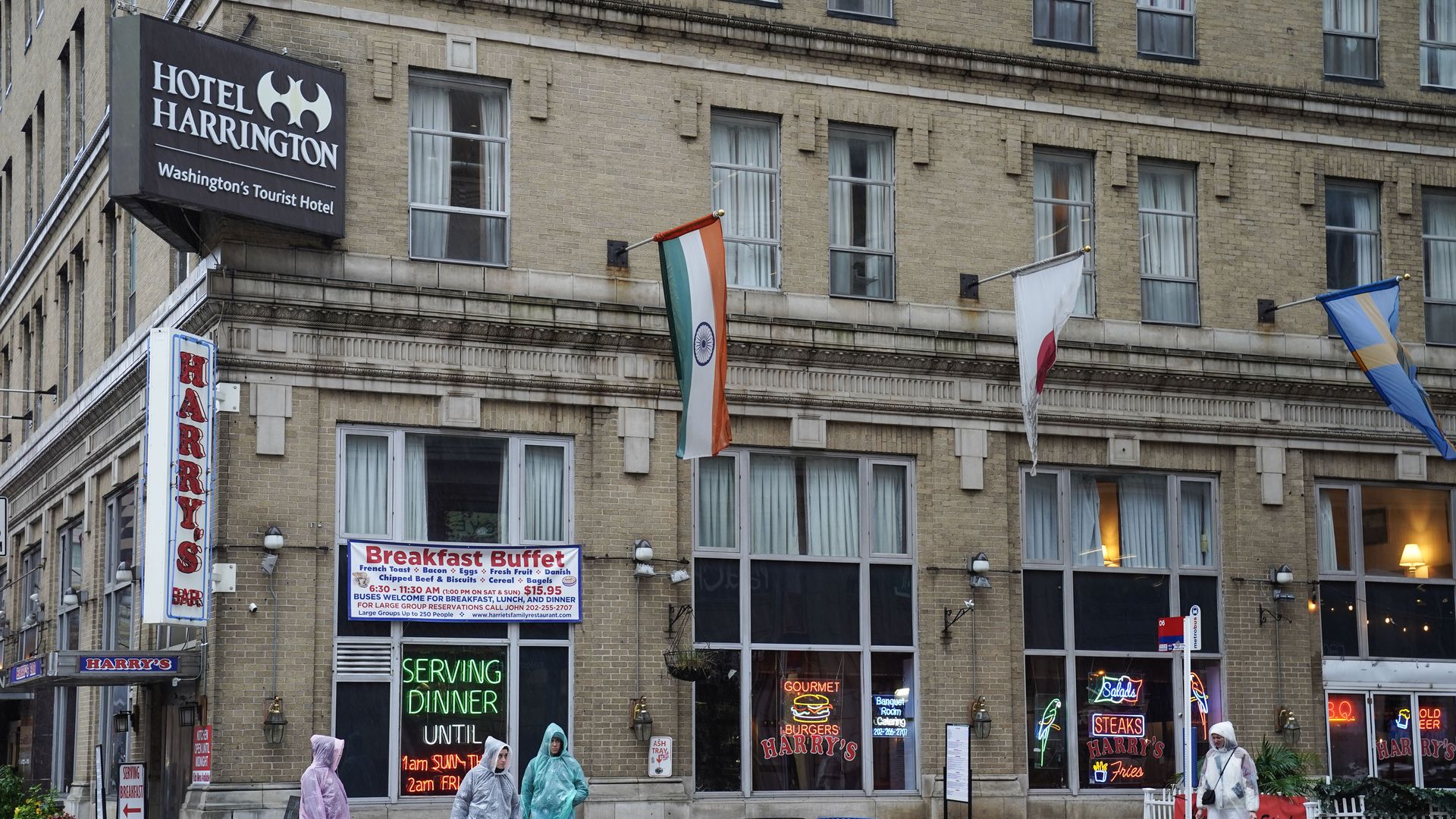 A photo showing the exterior facade of a hotel with a sign reading "Hotel Harrington."