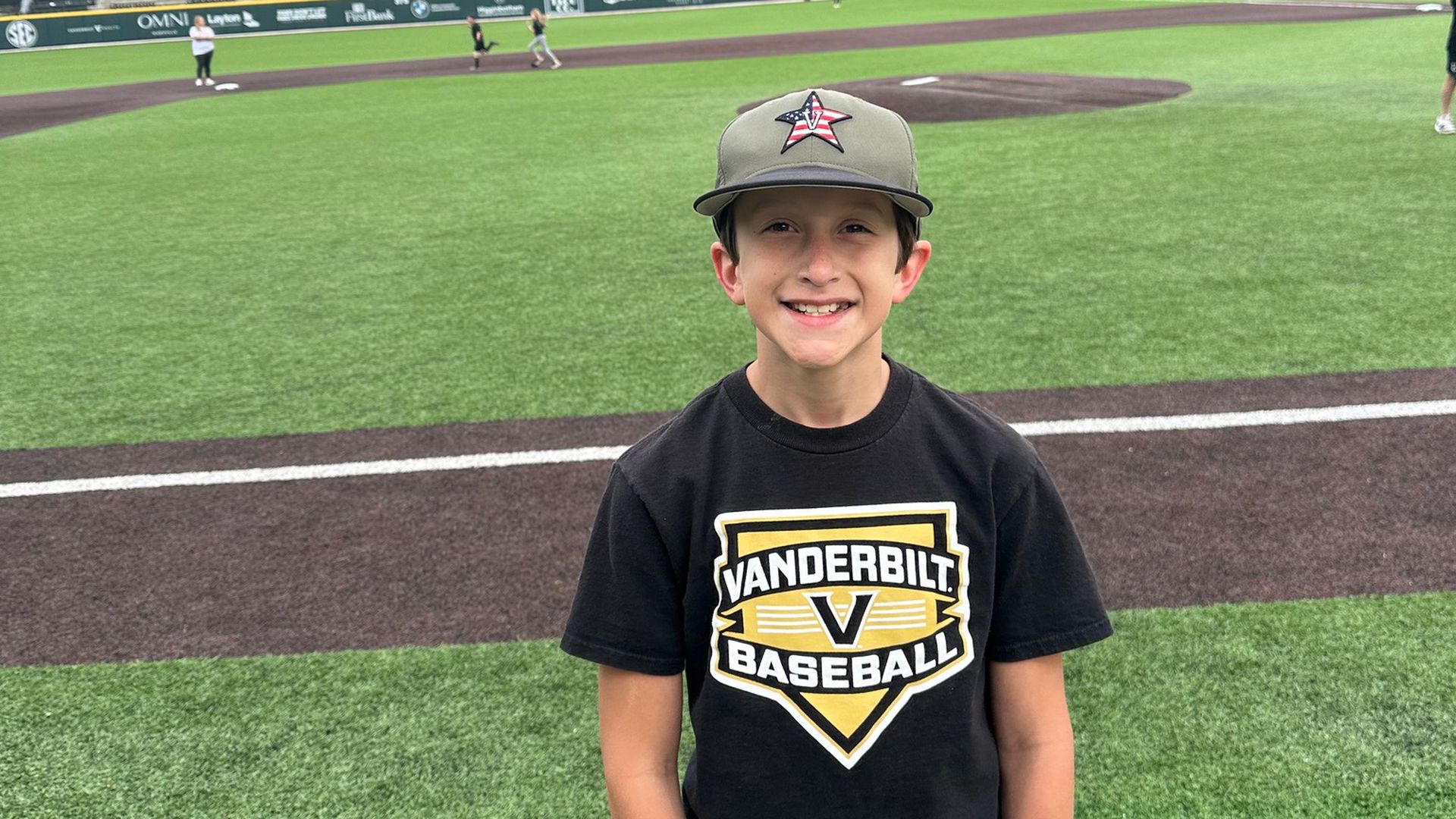 Asher Sullivan standing in front of a baseball diamond.