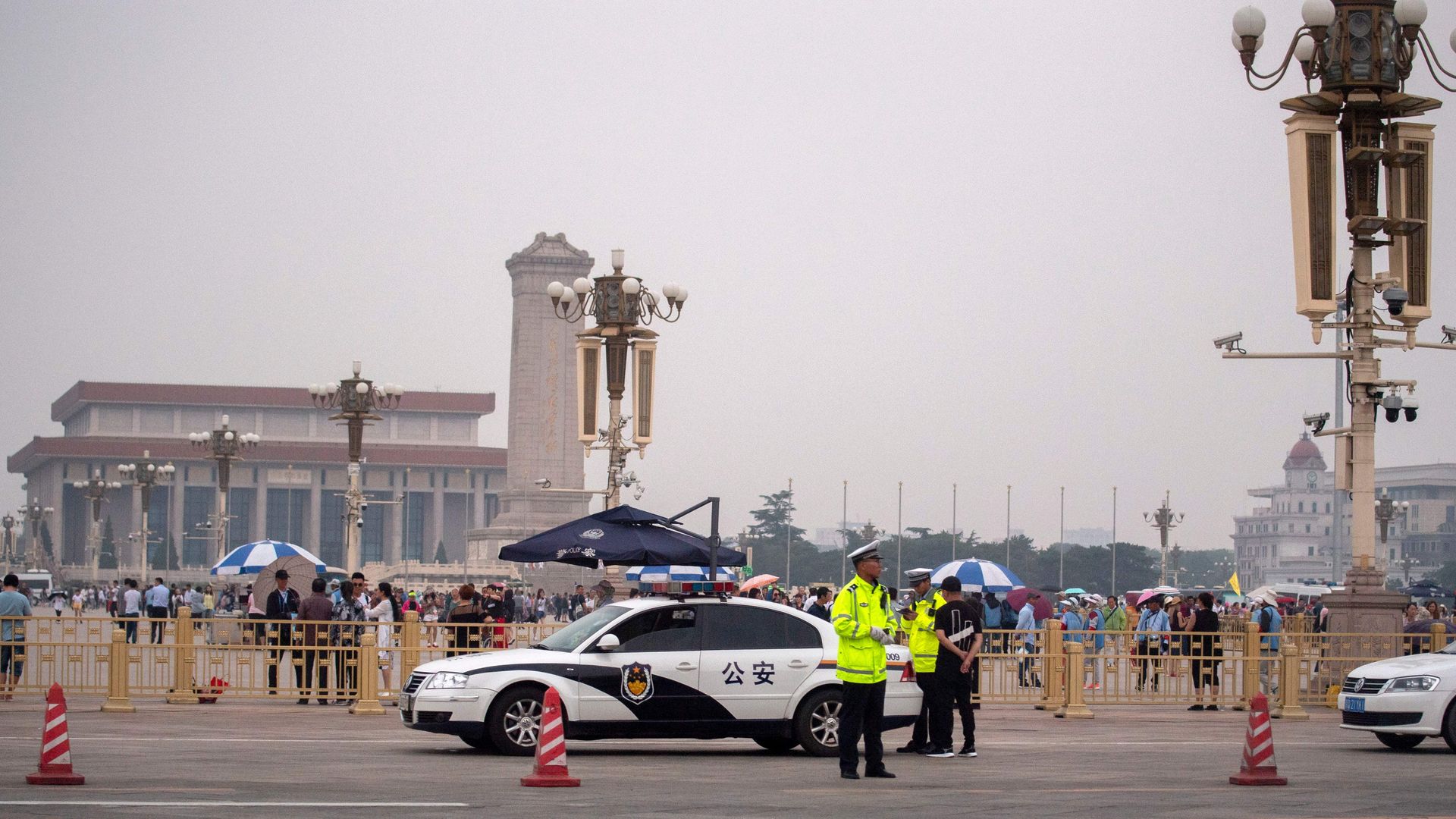 Police officers stand in front of Tiananmen Square in Beijing on June 4, 2019.