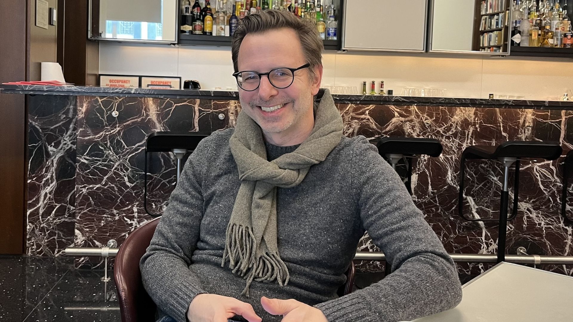 Jason Hammel sitting in front of a bar.