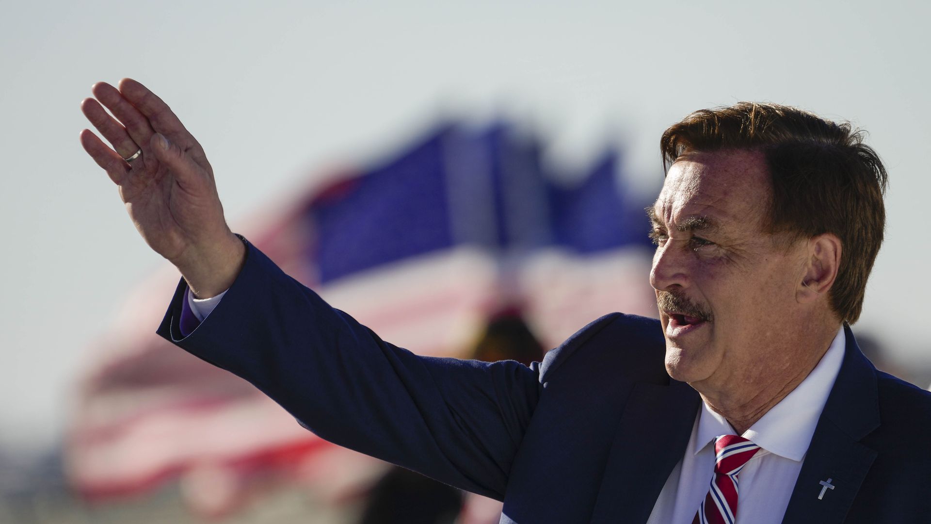 EO of My Pillow Mike Lindell waves to supporters of former U.S. President Donald Trump as they arrive for a rally at the Dayton International Airport on November 7, 2022
