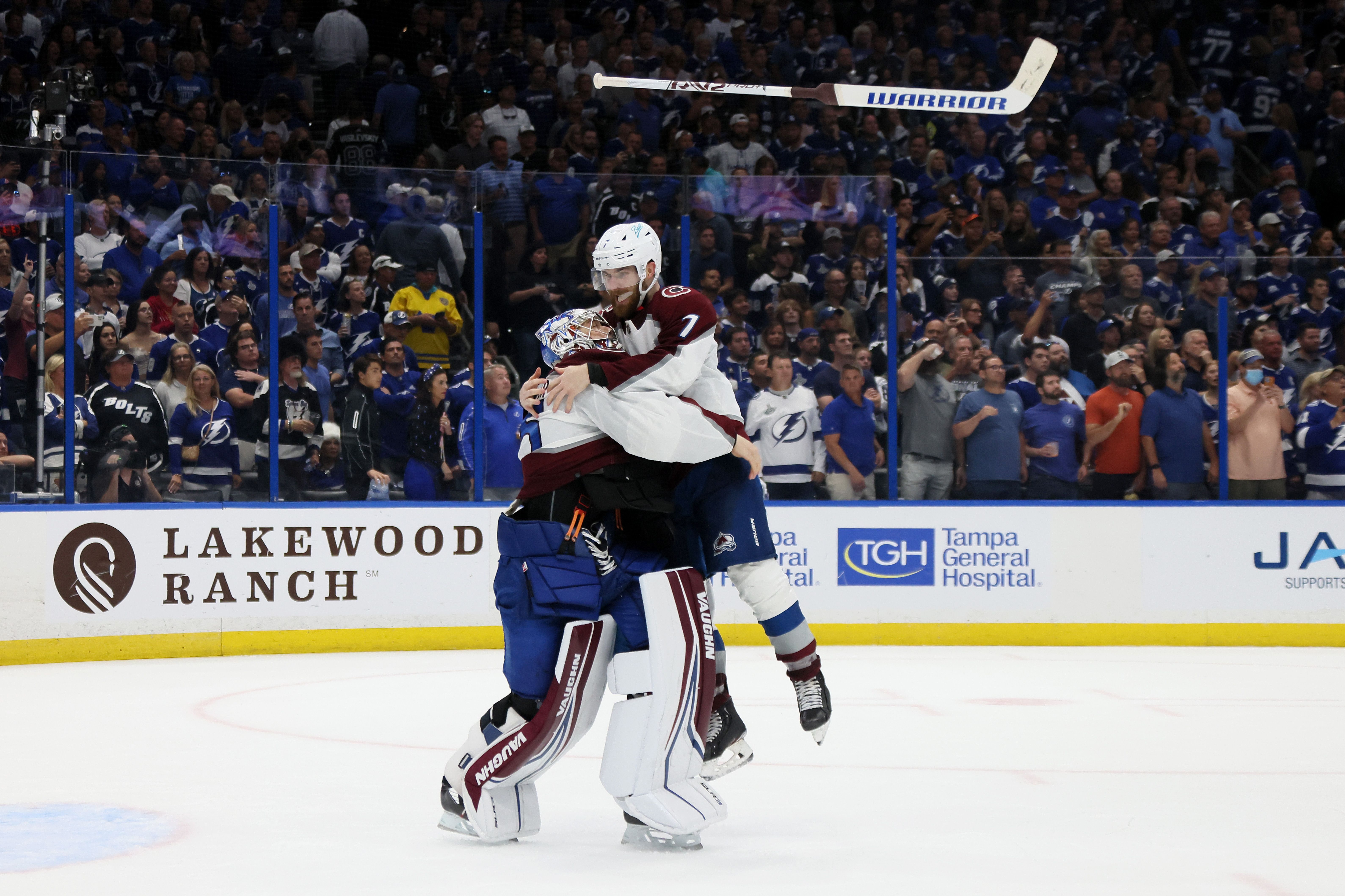 Darcy Kuemper #35 and Devon Toews #7 of the Colorado Avalanche celebrate after defeating the Tampa Bay Lightning 2-1 .