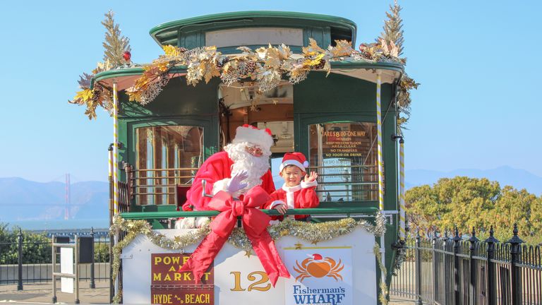 Santa ditches his sleigh for a San Francisco cable car - Axios San