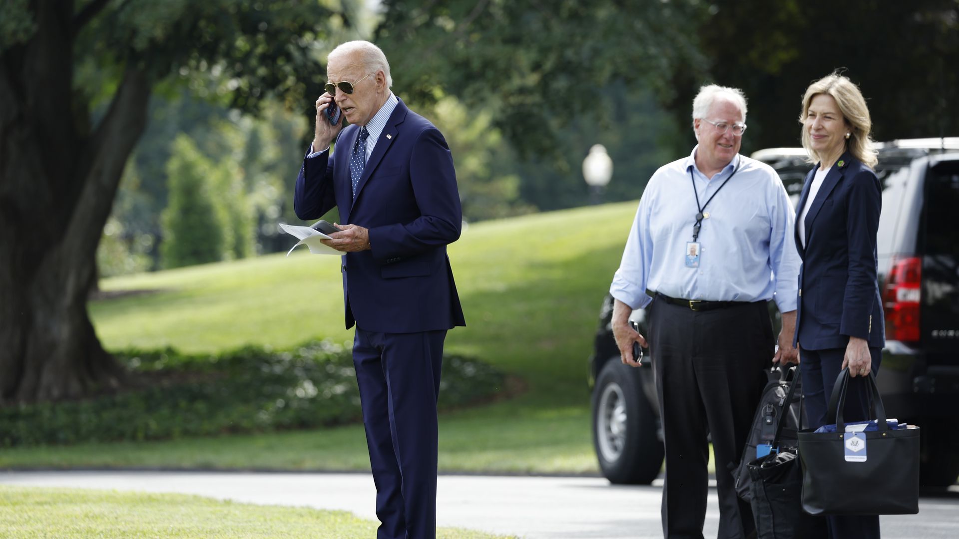 MIke Donilon stands behind Joe Biden, alongside Liz Sherwood-Randall