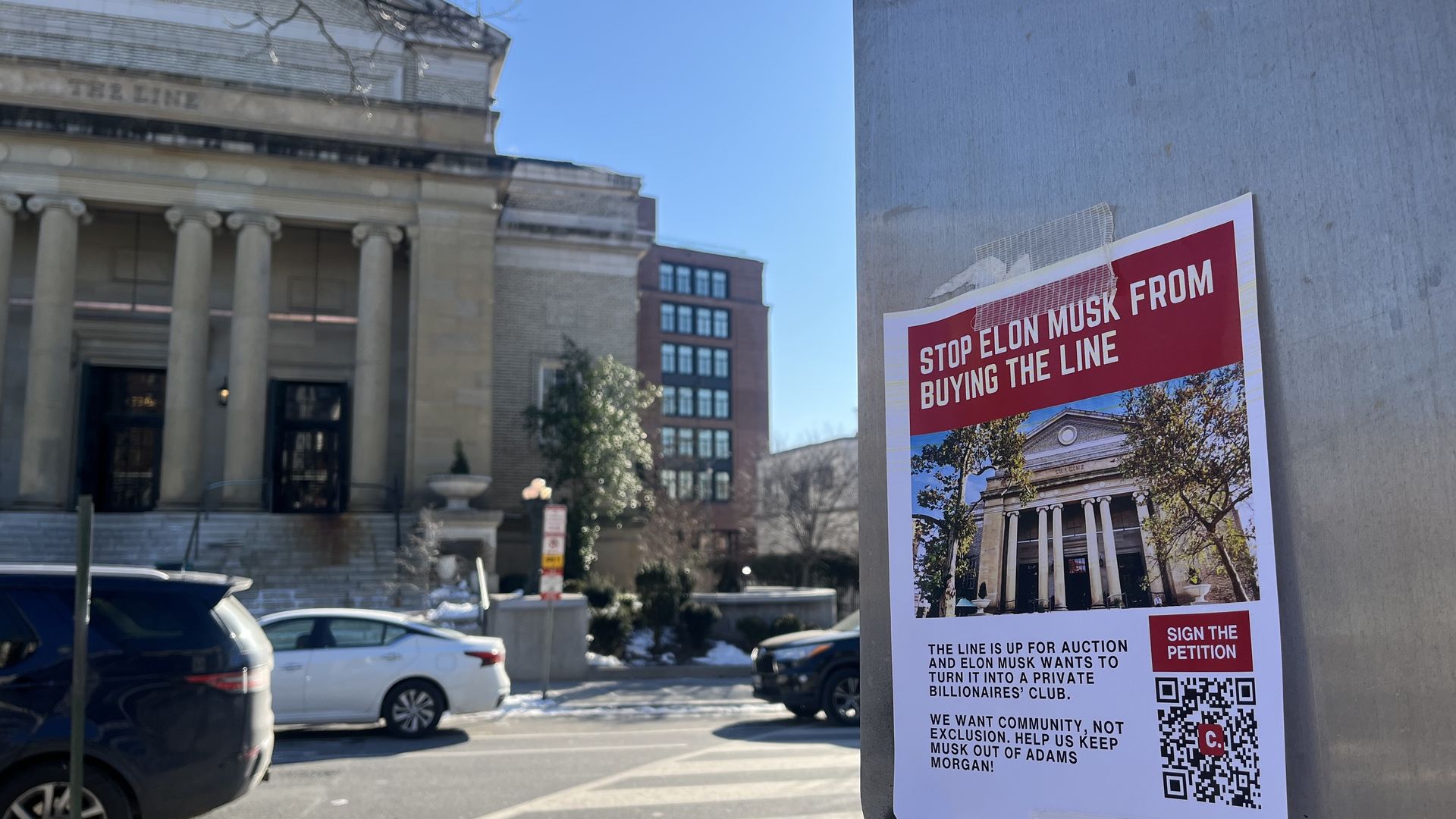 A poster opposing Elon Musk's purchase of the Line hotel, which is in the background