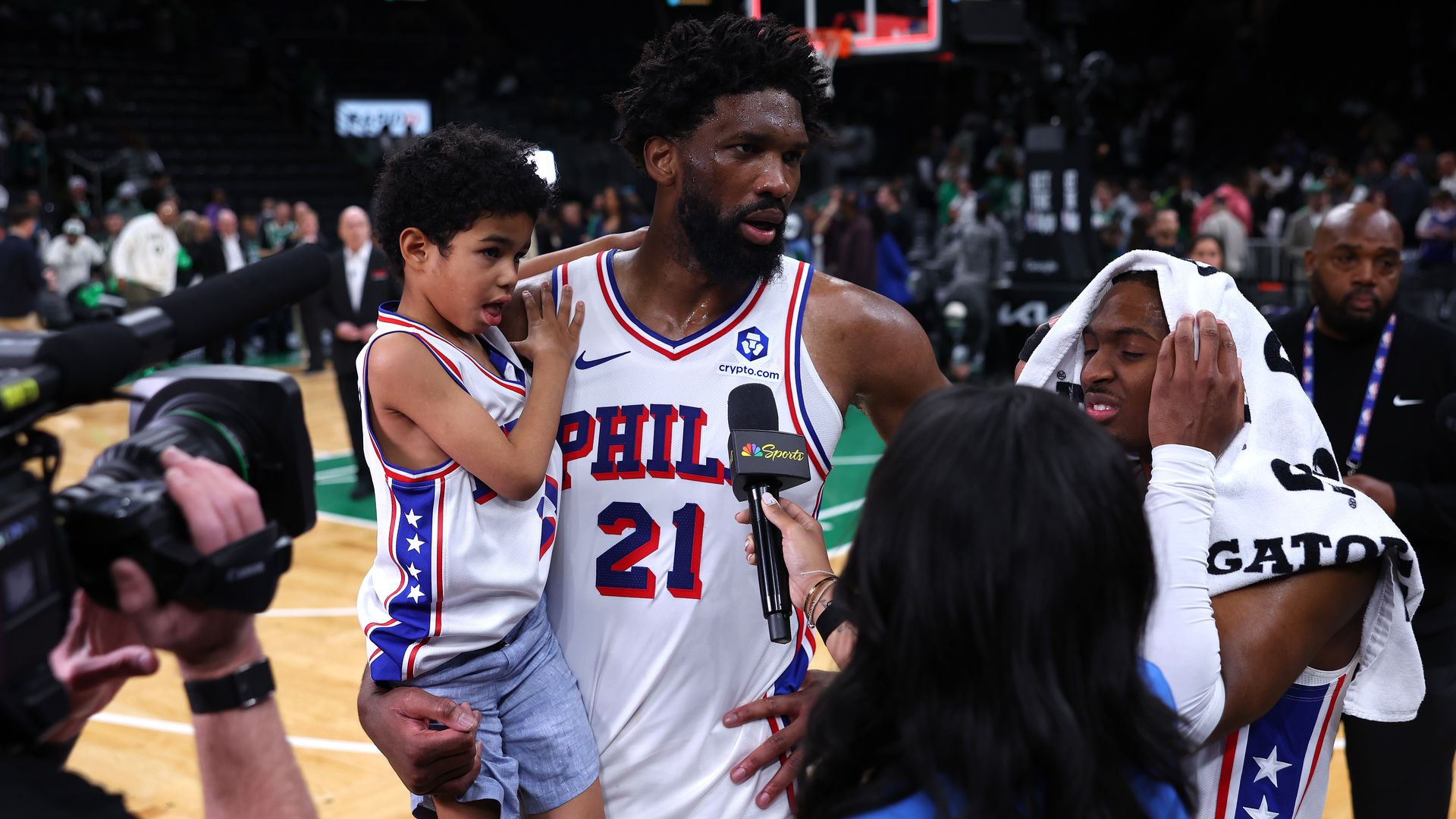 Sixers center Joel Embiid, with his son in hand, is interviewed after defeating the Celtics 109-100 in Game 7 of their first-round playoff matchup.